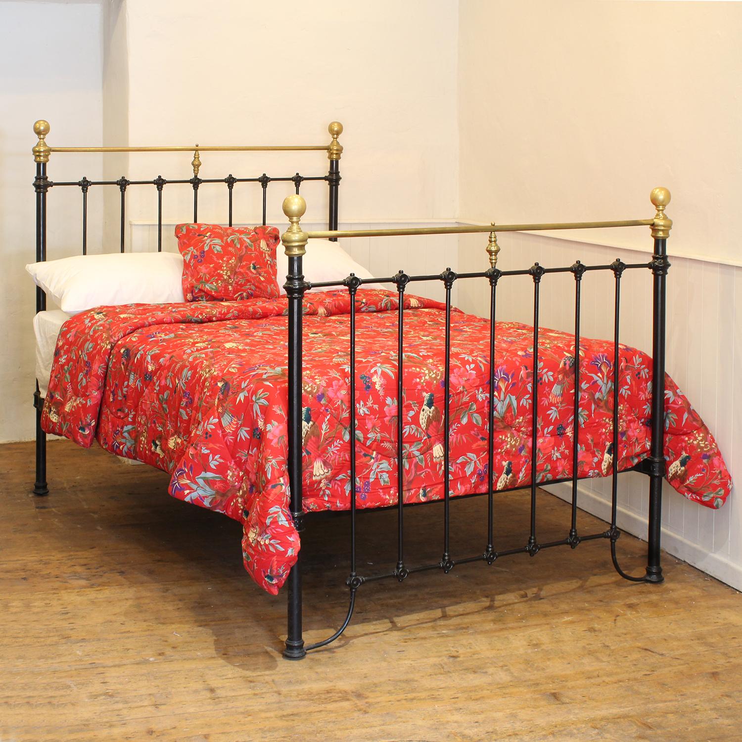 A Victorian brass and cast iron bedstead finished in black with curved brass top rails.

This bed accepts a double size 4ft 6in wide (54 inch or 135cm) base and mattress. 

The price includes a firm standard bed base to support the