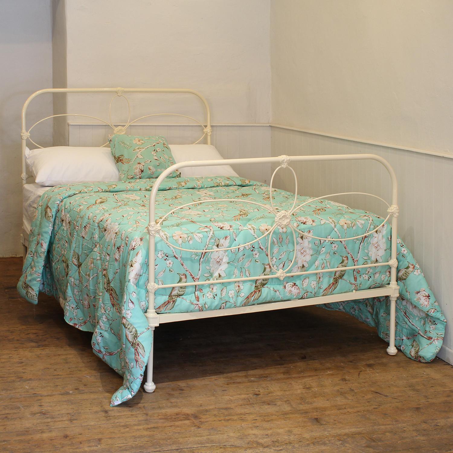 A Victorian cast iron bedstead finished in cream with arch shaped panels and dainty, decorative castings.

This bed accepts a double size 4ft 6in wide (54 inch or 135cm) base and mattress. 

The price includes a firm standard bed base to support