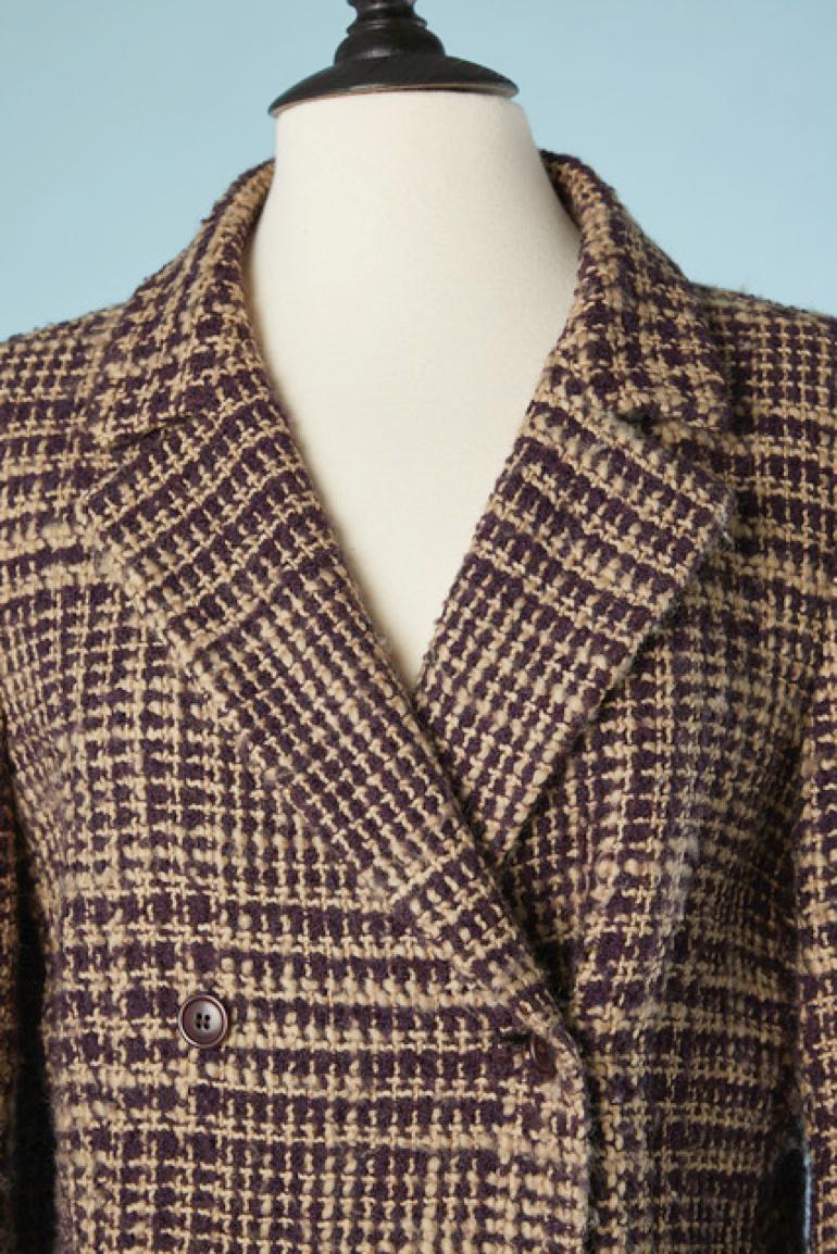 Double breasted coat with check pattern. 
Main fabric composition: 85% wool, 10% mohair, 5% nylon. Lining composition: 60% rayon, 40% acetate. 

Pocket on both side. Shoulder pad. Button and buttonhole closure on the middle front. Half-belt on the