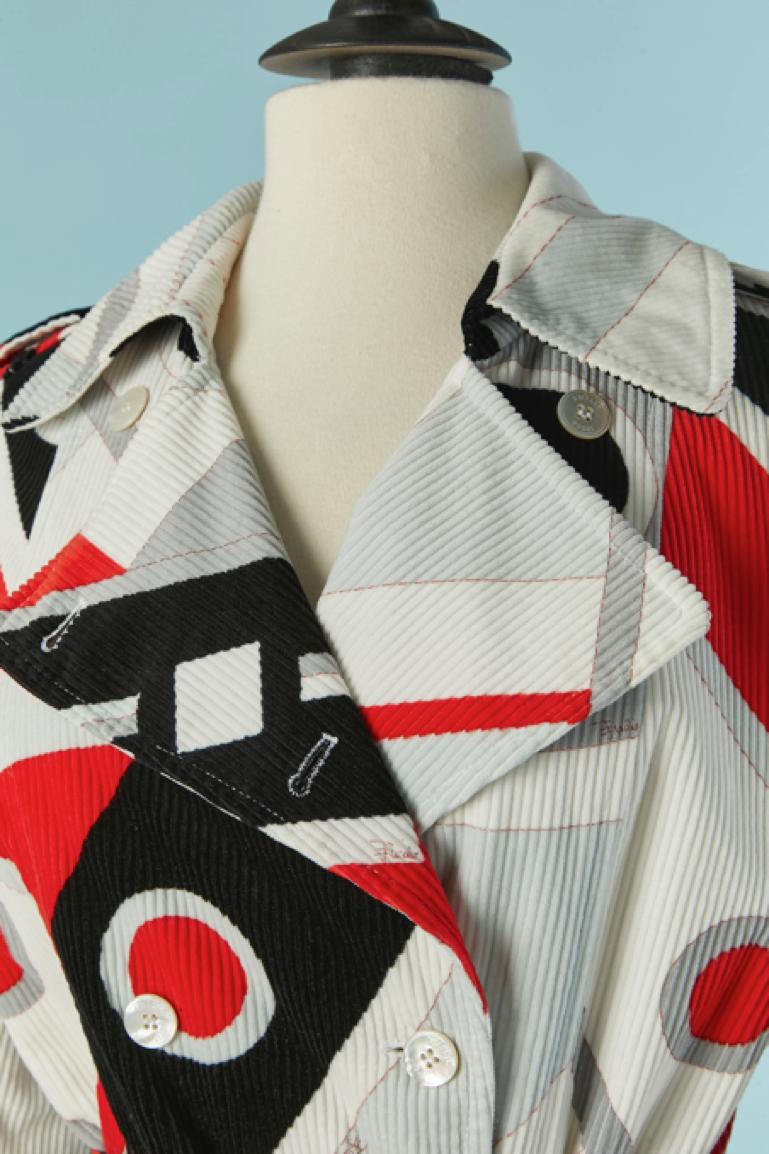 Double-breasted lightly padded printed cotton Corduroy coat. 
Lining composition: 62% acetate, 38% rayon.
Branded button closure on the middle front + 2 extra buttons provided. Pockets on both side. Belt in the same fabric and belt-loop. Split on