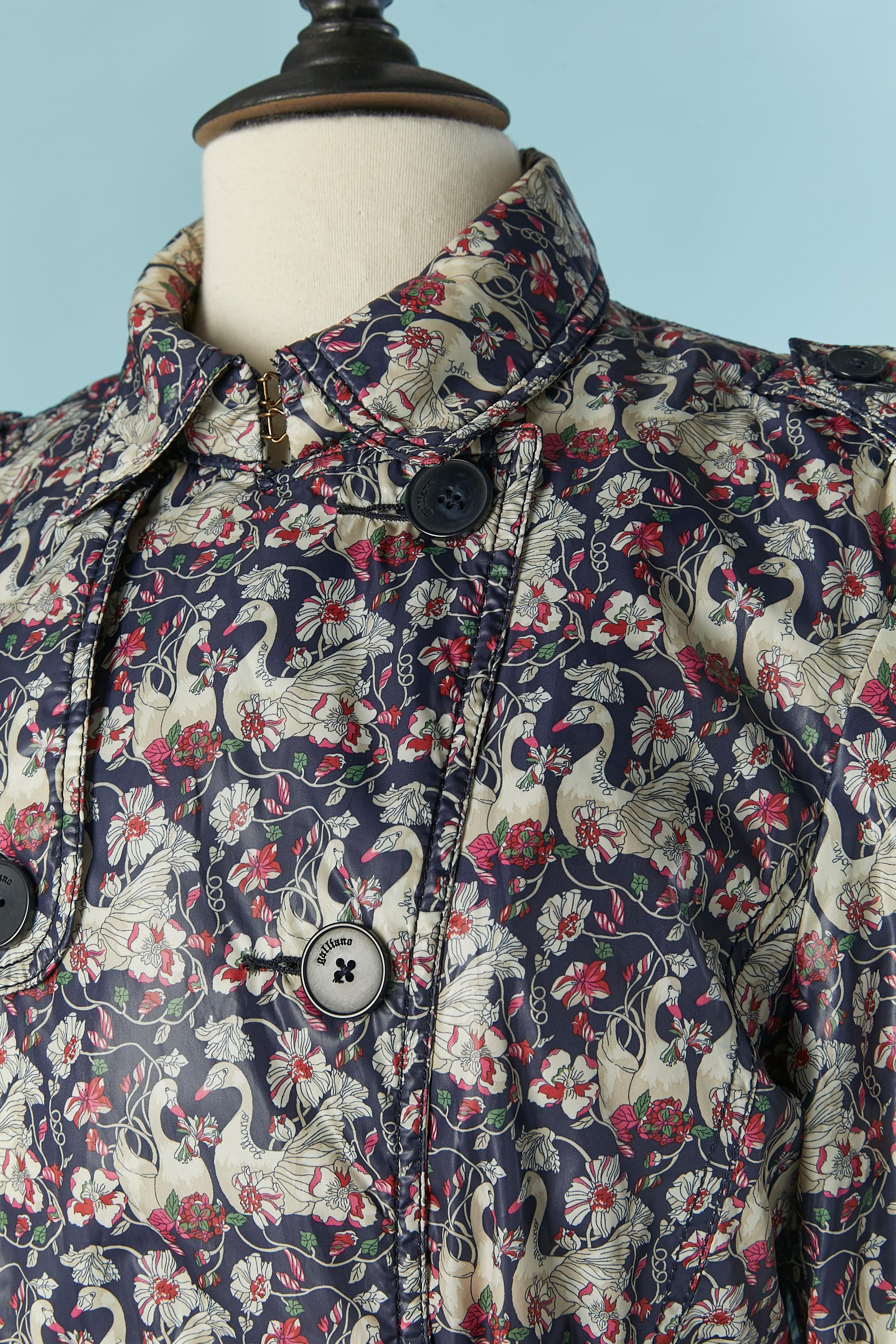 Double breasted lightly padded printed trench-coat with swan and flower print . Outside fabric, lining and padding composition: 100% polyester. Branded button and buttonhole closure on the middle front, on the pocket flap and on the cuff. Belt in