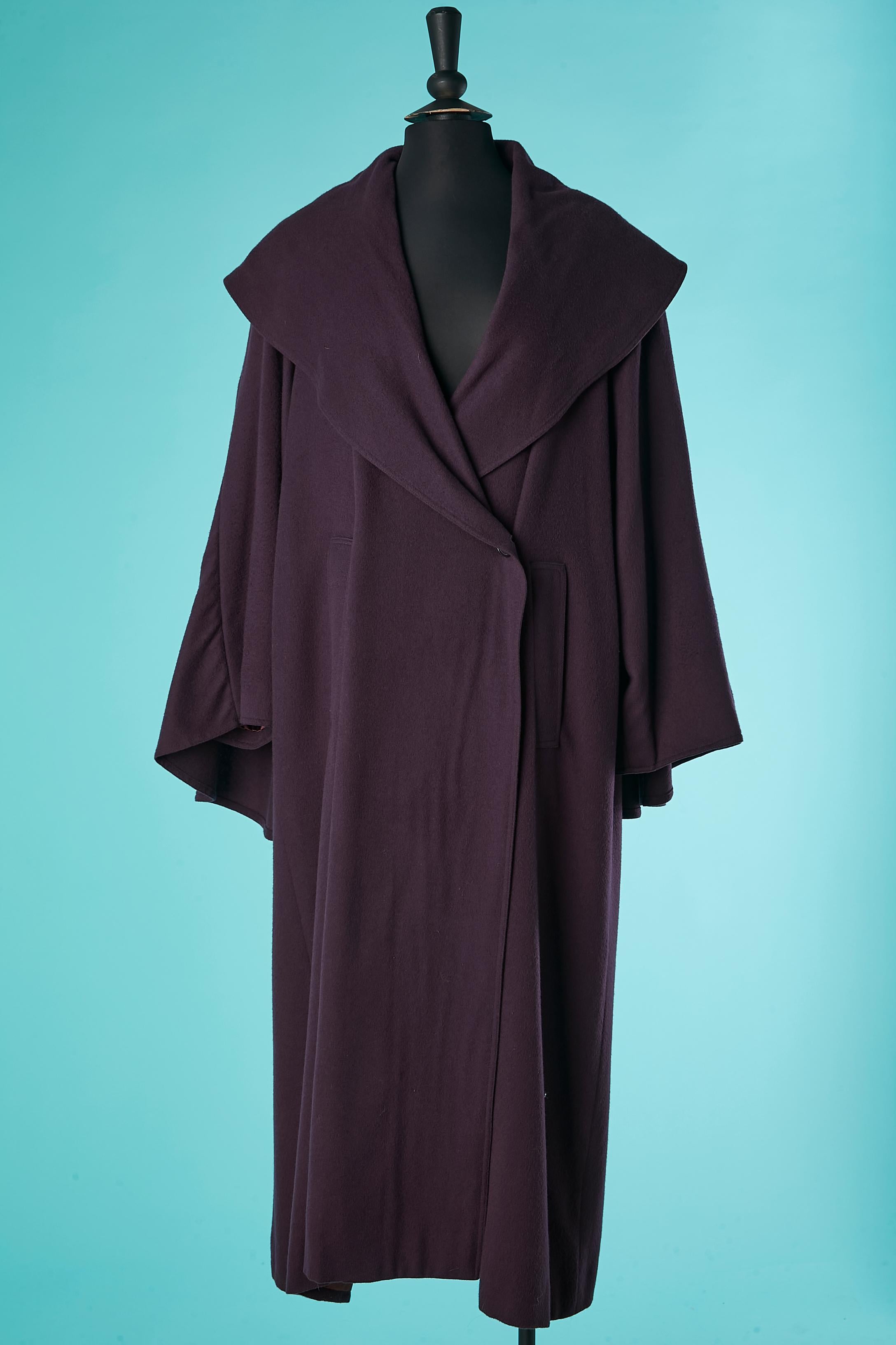 Double-breasted purple wool coat with cape on the back. Pocket on both side. Shoulder-pad. 
One hidden button and one visible button on the middle font . Burgundy satin lining. 
This coat could be by  K Lagerfeld who design Chloé Collection from