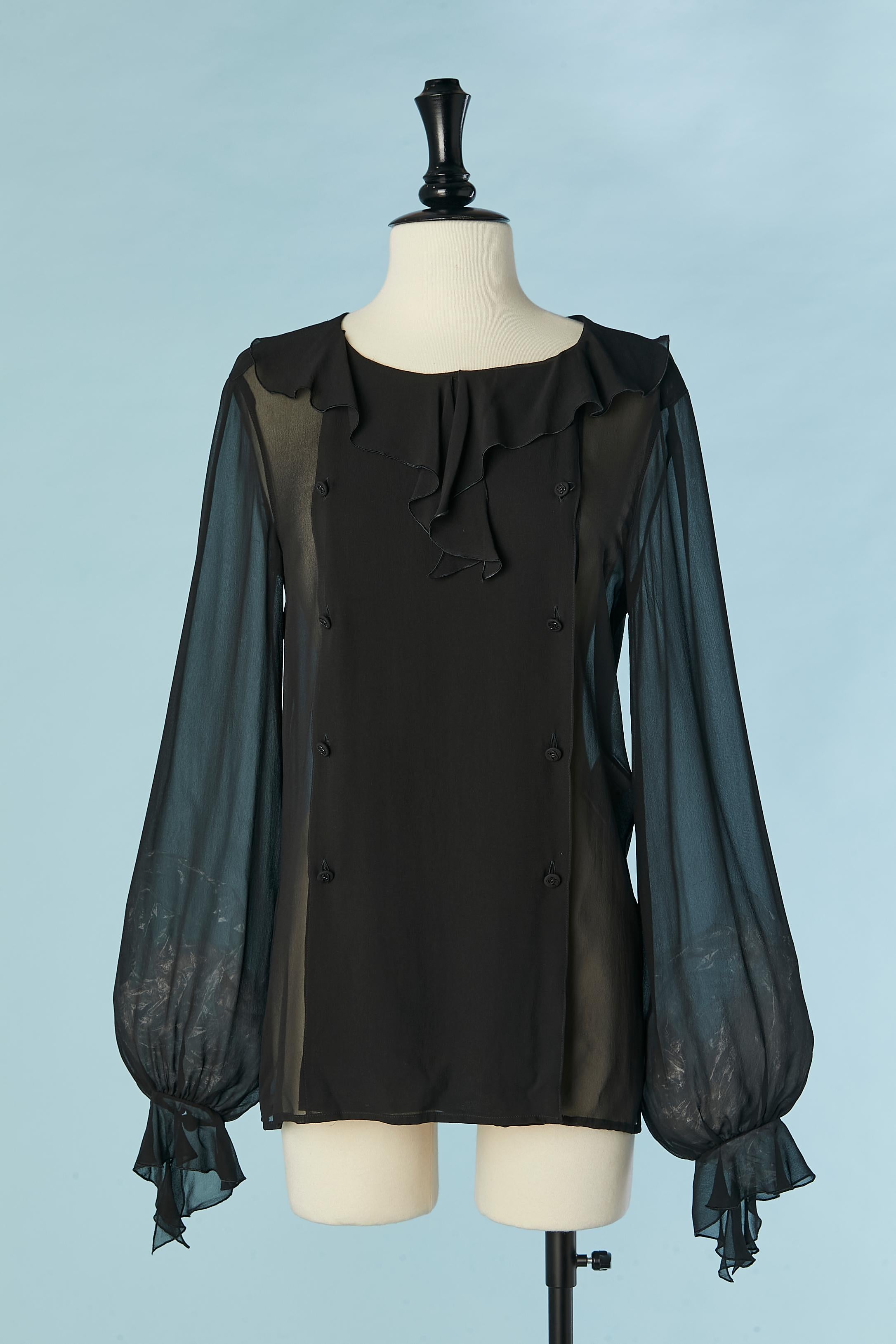 Black see-through double-breasted silk chiffon shirt with ruffle on the collar and cuff. Branded button in the middle front and on the cuffs. 
The size tag has been cut but fit  40 (Fr)/ L 