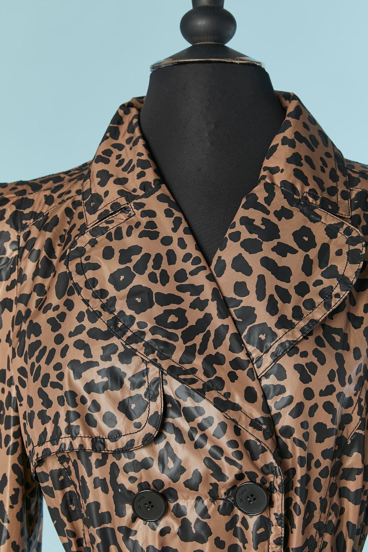 Double breasted trench-coat with leopard print. Fabric composition and branded lining: 100% polyester. Shoulder pad. 
Branded button closure on the middle front and cuffs.  Belt in the same fabric and belt-loop. Pocket on both side. Split on the
