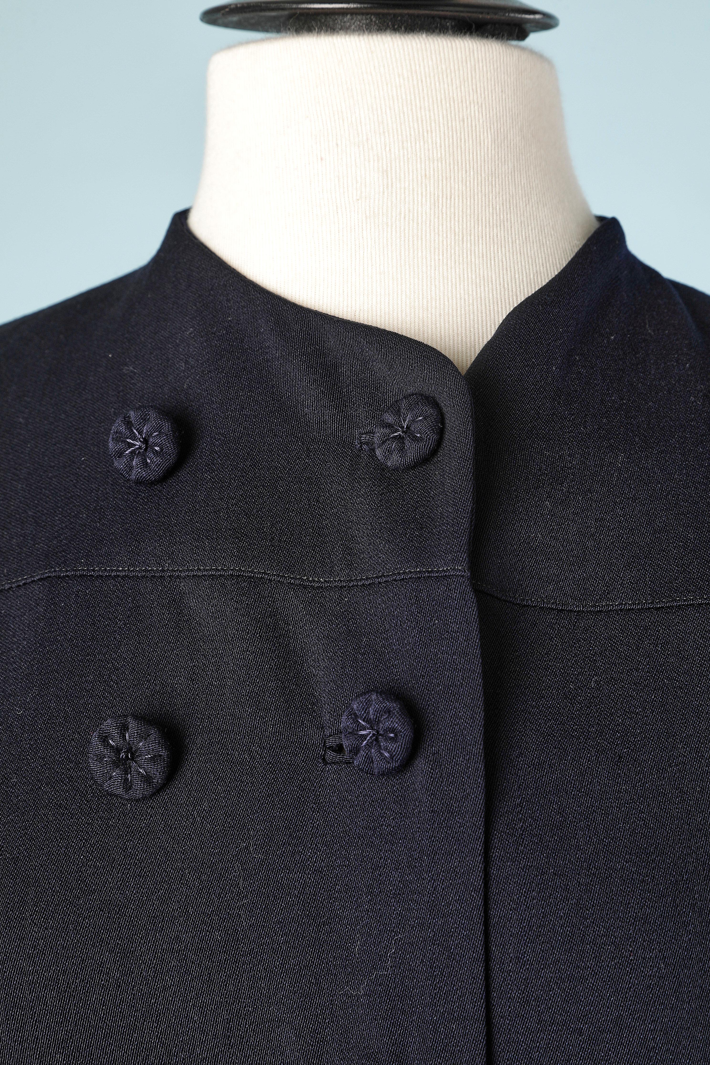 Double-breasted wool coat with pleated sleeves.Cape effect. Silk lining. Fabric covered buttons. Size L 