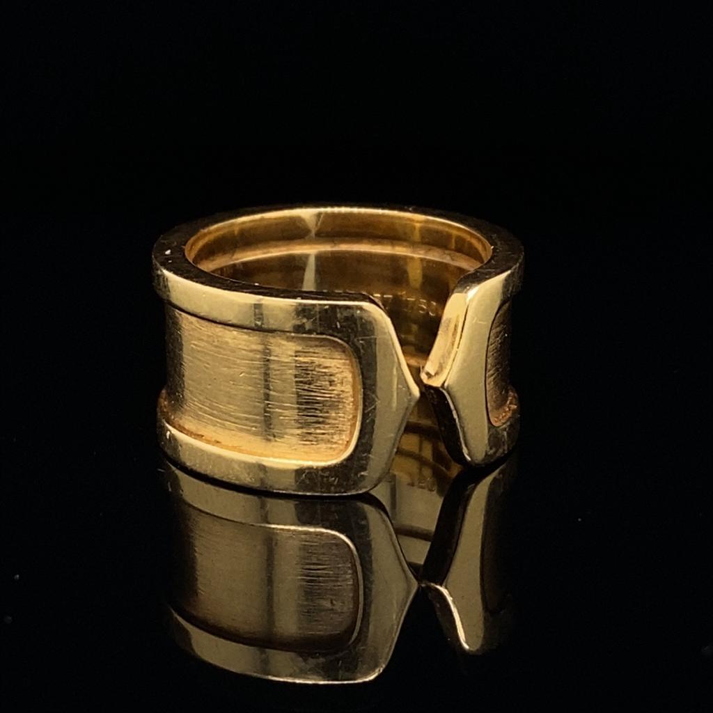 A Double C Cartier ring in 18 karat yellow gold, circa 2000.

Featuring Cartier's instantly recognizable double C, this rare and unusual version of the iconic C de Cartier ring has a brushed inner finish and is wider than the average Double C ring