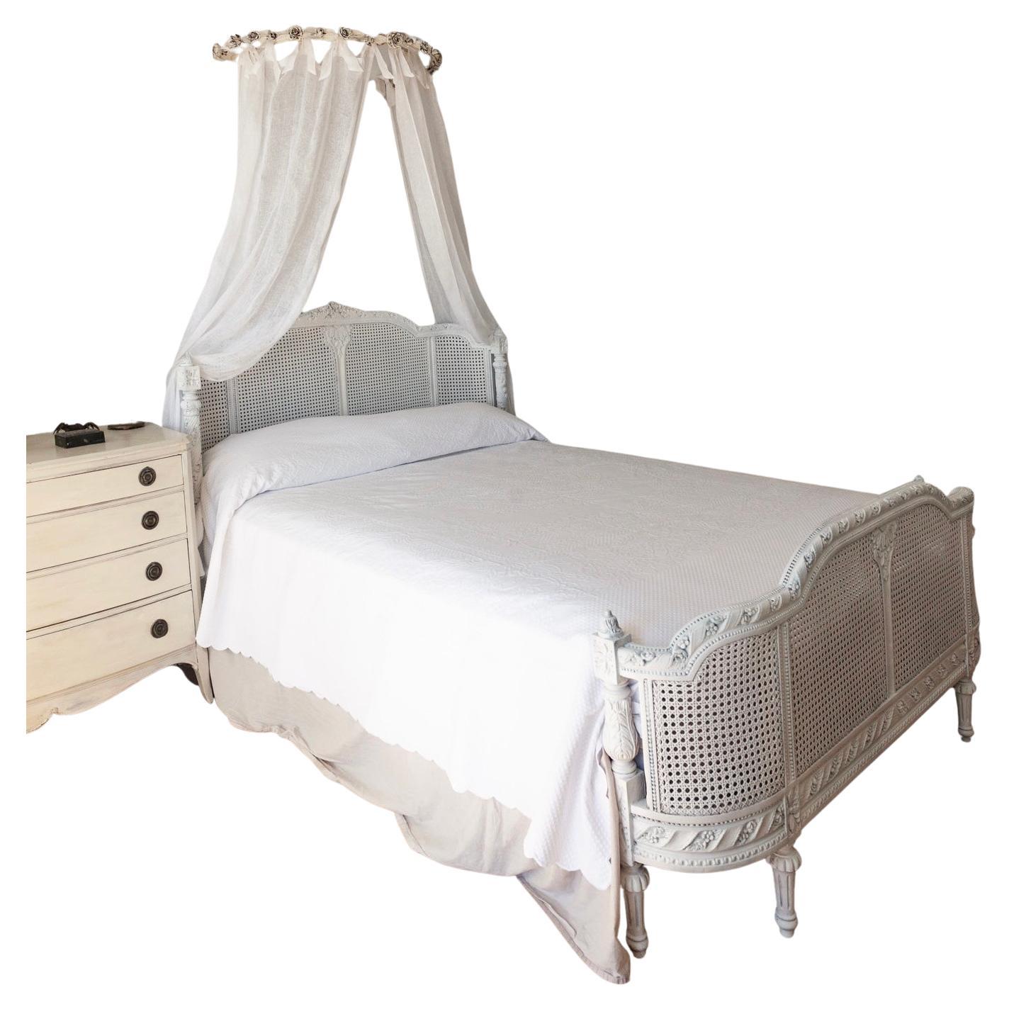 Weißes handgeschnitztes französisches Euro-King-Doppelbett. Hartholzrahmen aus dem frühen 20. Jahrhundert mit geschnitzten Details und doppeltem Kopf- und Fußteil aus Rohr. In sanftem Weiß gehalten. Maße: 91