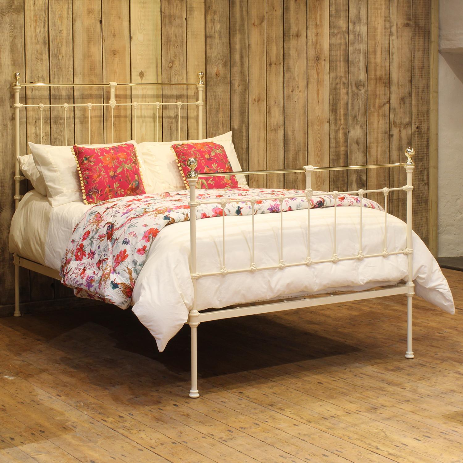 A Victorian cast iron bedstead finished in cream with dainty design, attractive castings and brass top rail, cap collars and knobs.

This bed accepts a double size 4ft 6in wide (54 inch or 135cm) base and mattress. 

The price includes a firm