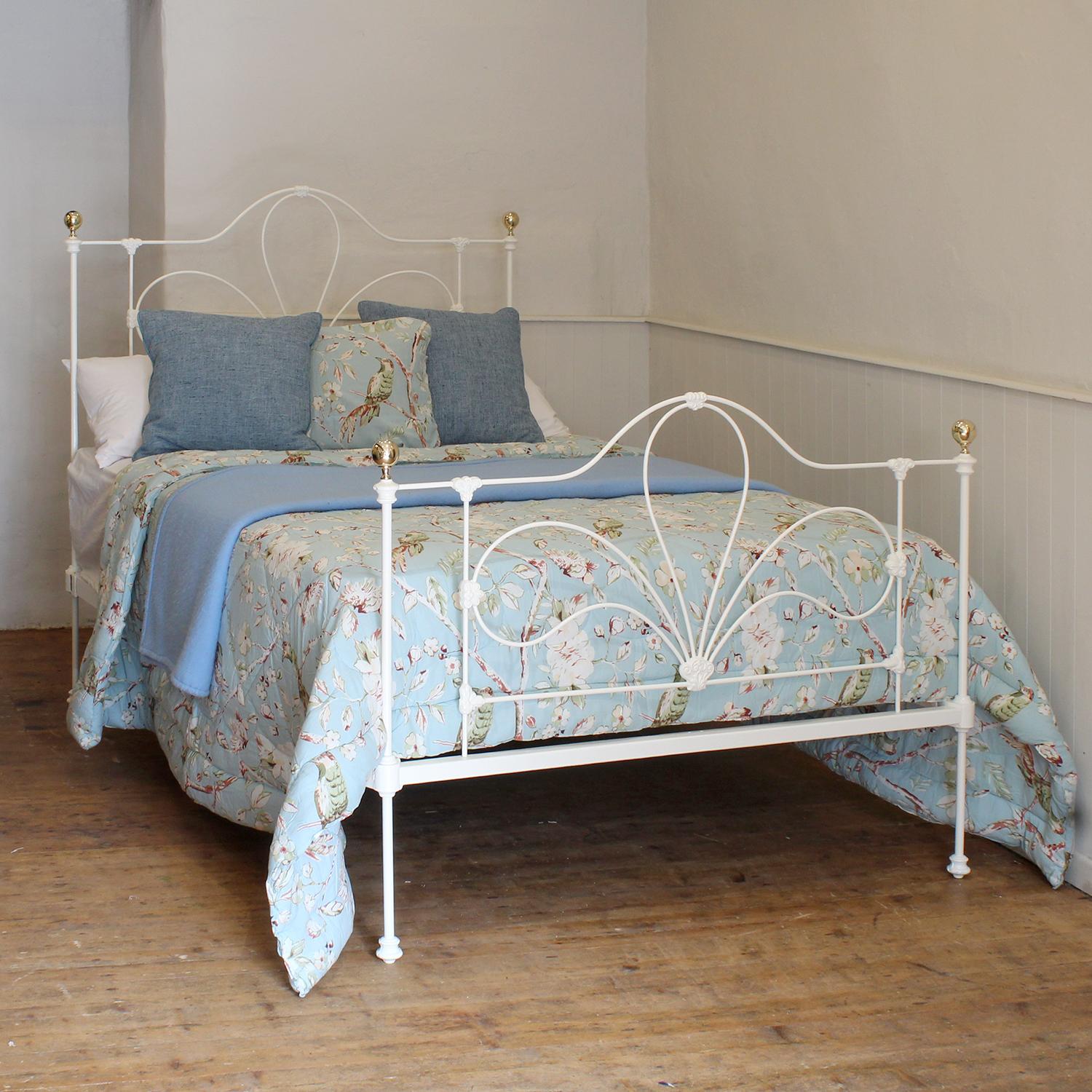A Victorian cast iron bedstead finished in white with shaped panels and dainty, decorative castings.

This bed accepts a double size 4ft 6in wide (54 inch or 135cm) base and mattress. 

The price includes a firm standard bed base to support the