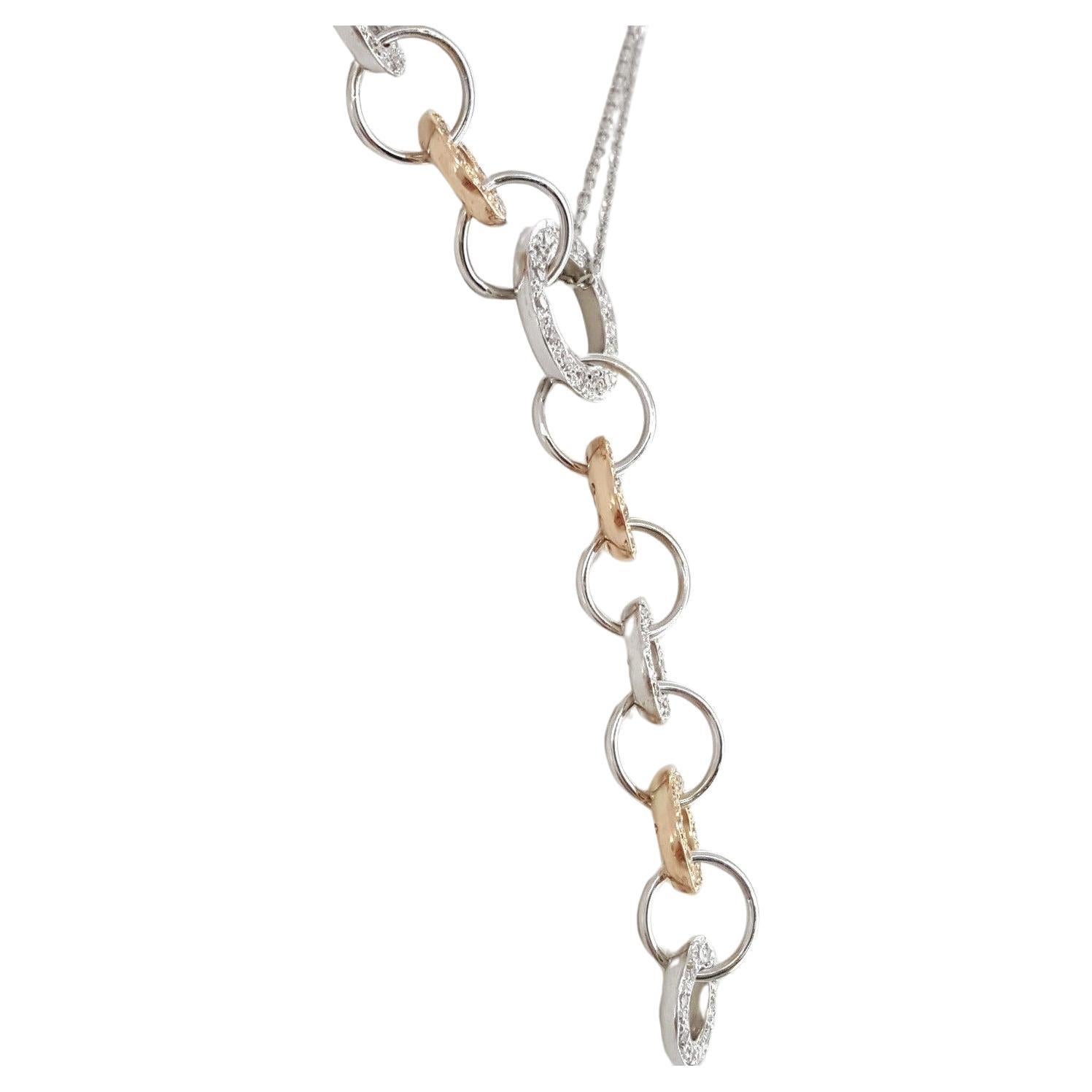 A Double Chain Necklace crafted in 18k White & Rose Gold features Overlapping Circles adorned with Round Brilliant Cut Diamonds. The necklace is adorned with 86 Natural Round Brilliant Cut diamonds, totaling around 0.75 carats, with H-I color and