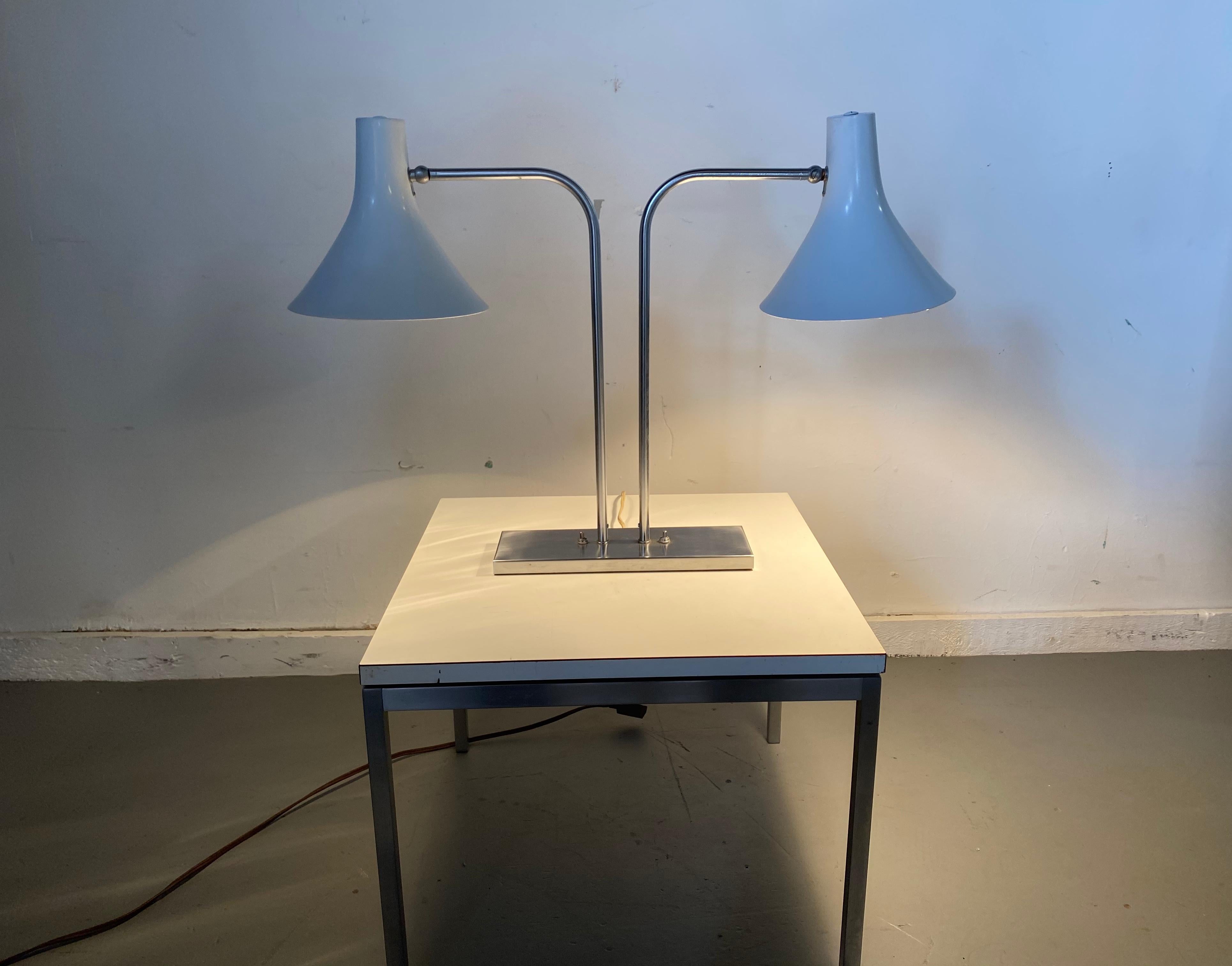 Iconic desk lamp with pivot and swivel cone shades designed by Greta Von Nessen for Nessen Studios. Lamp is constructed with brushed nickel with lacquered shades. Amazing original condition.