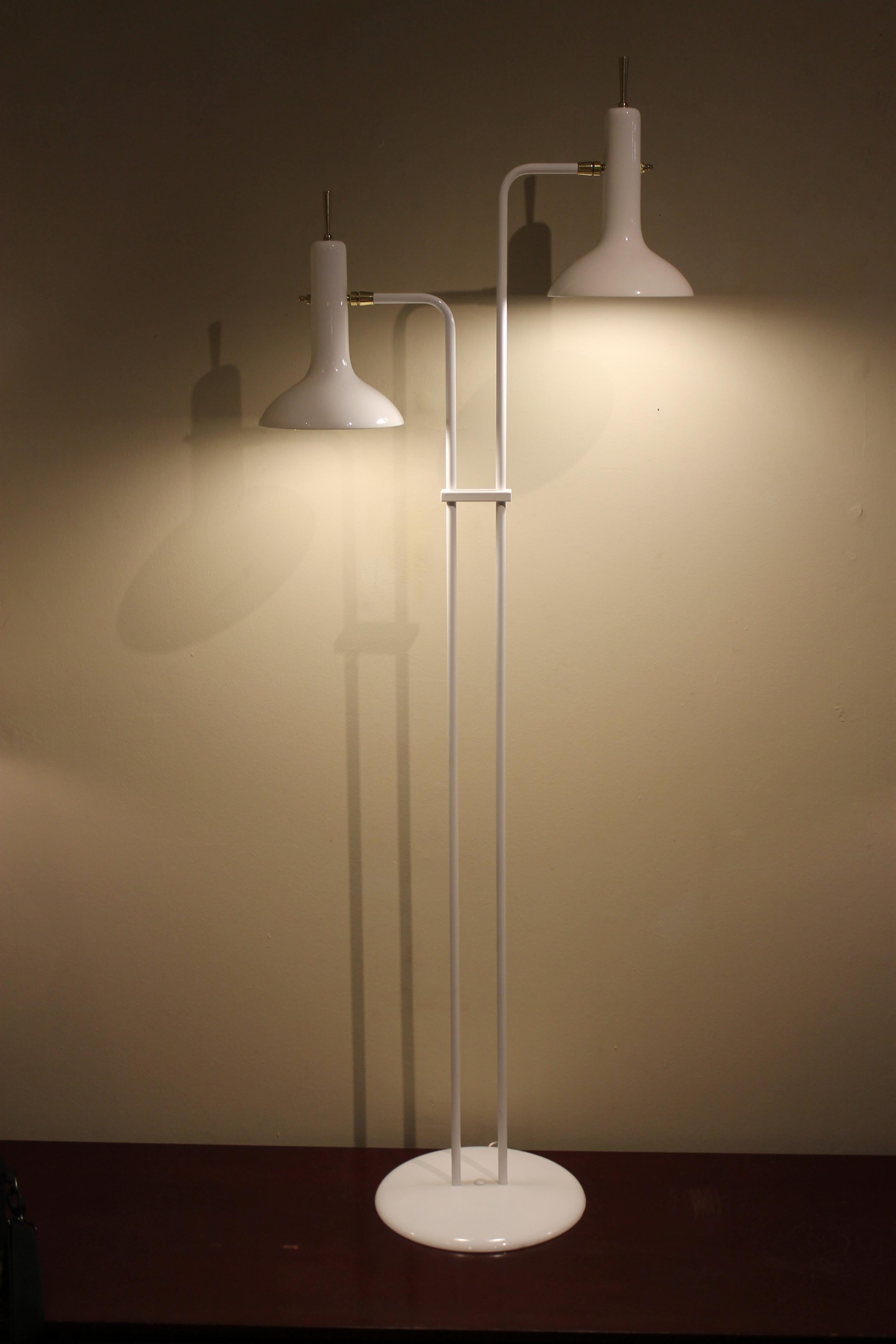 Laurel floor lamp has been updated by sand blasting and powder coating it white.  It’s been professionally rewired with the addition of new brass parts and finials to modernize it. Cones are 9” high and 7.25” diameter.  Base is 11.5” diameter. 