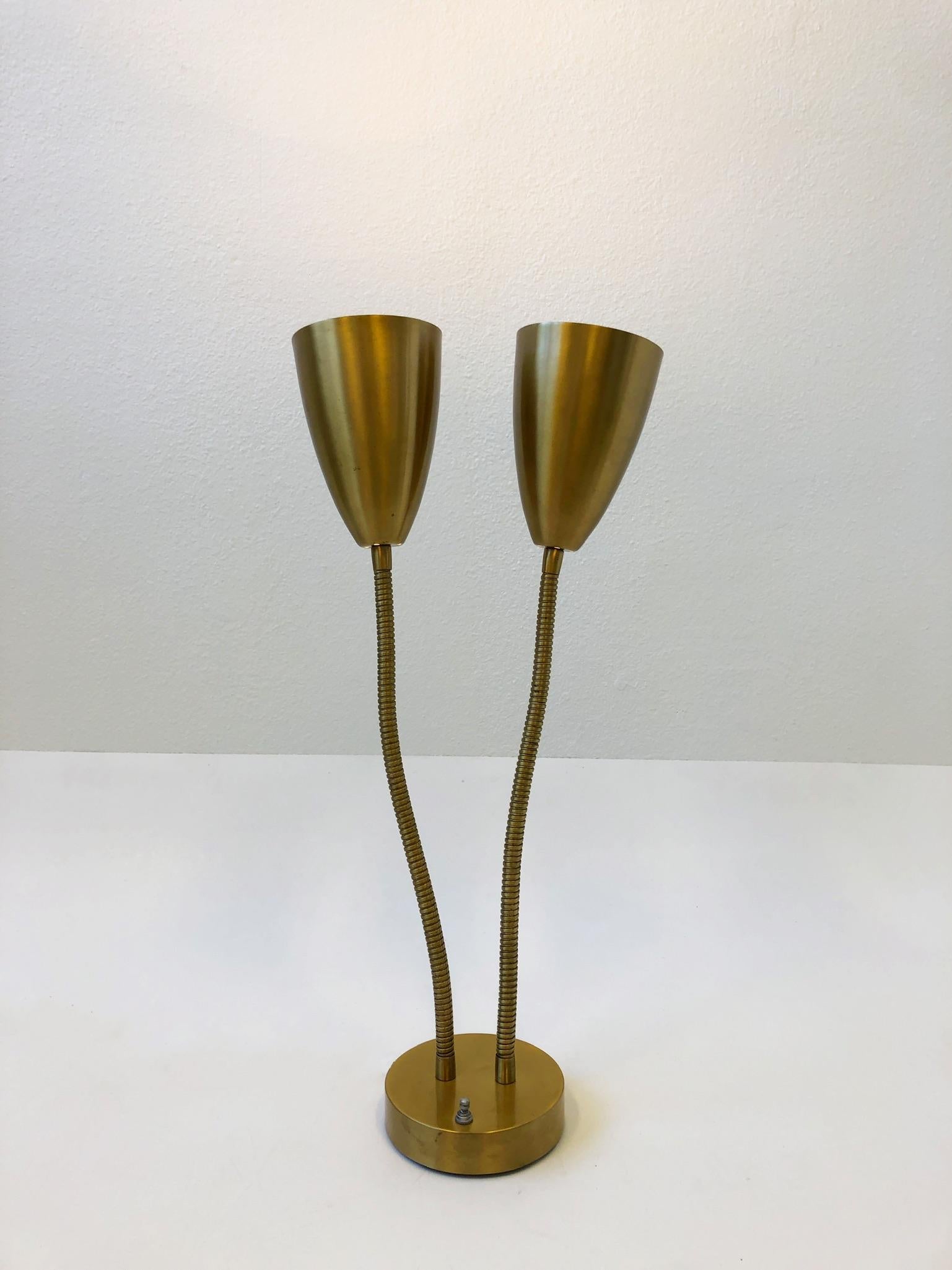 1950s double cone satin brass gooseneck table lamp. The lamp has been newly rewired with a three way rotating switch. Each cone can be moved around easily. The lamp shows some age spots(see detail photos).
Measurements: 14” wide 6” deep and 27”