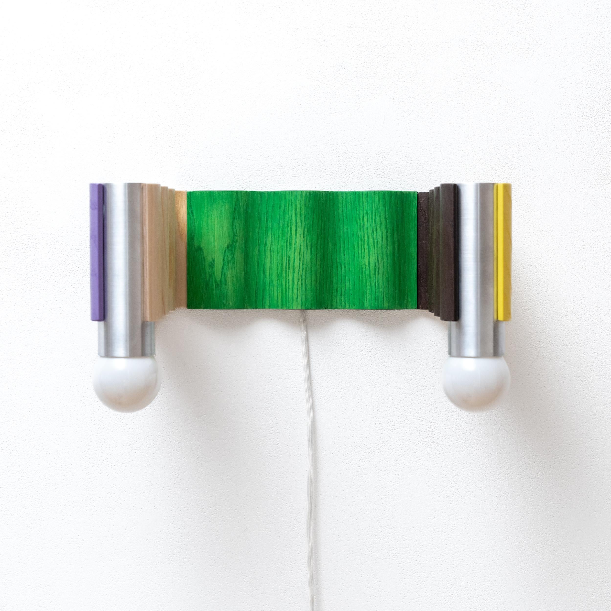 Multi-coloured double sconce made from ash veneered plywood (painted purple, clear coated, stained green, brown painted, yellow painted) and brushed aluminium tubes. Designed for Fels's exhibition 