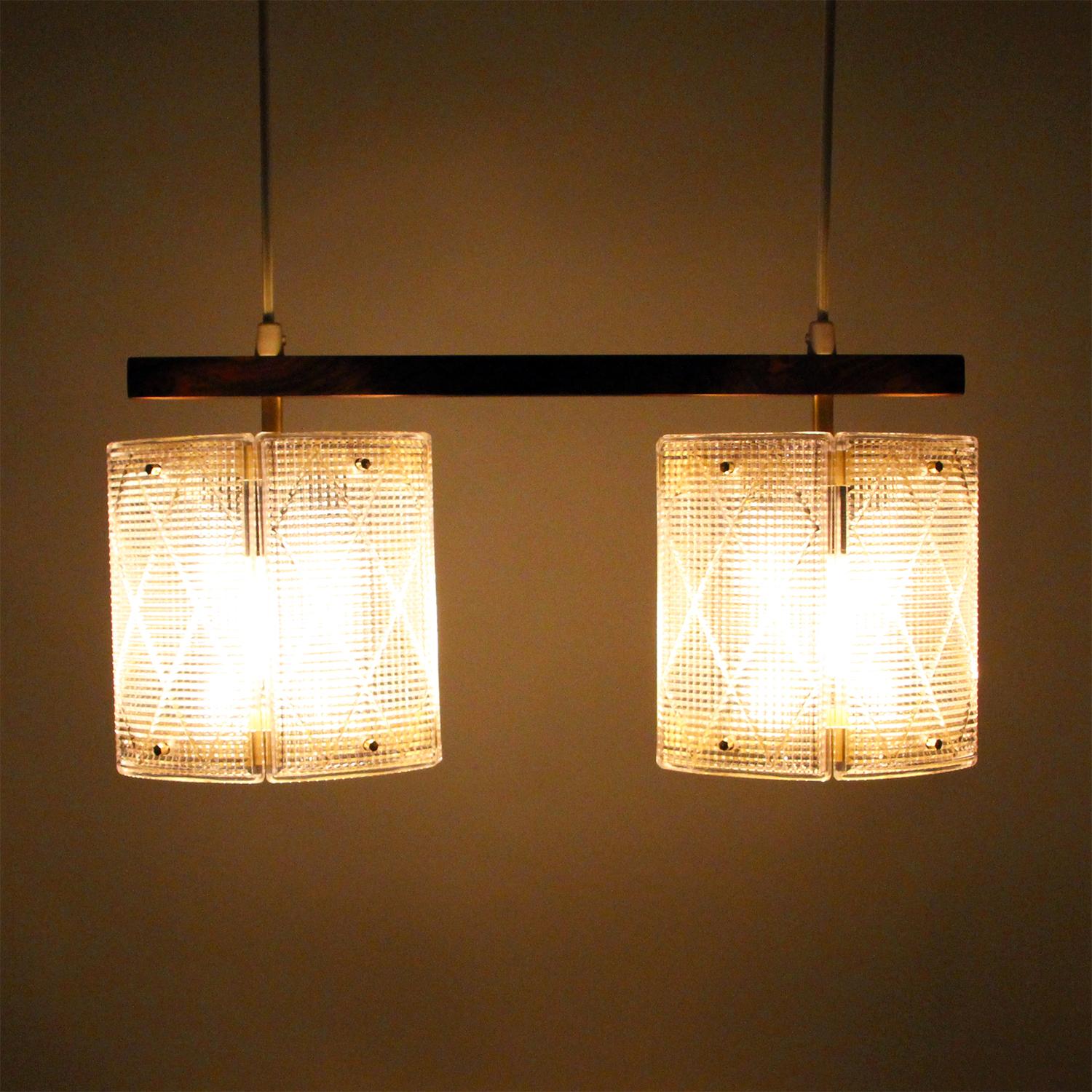 Double crystal light fixture by Swedish Eriksmålaglas (presumed) in the 1950s, super attractive Scandinavian Modern crystal glass with dark wood hanging light in excellent vintage condition.

Gorgeous light fixture, comprised of two crystal glass