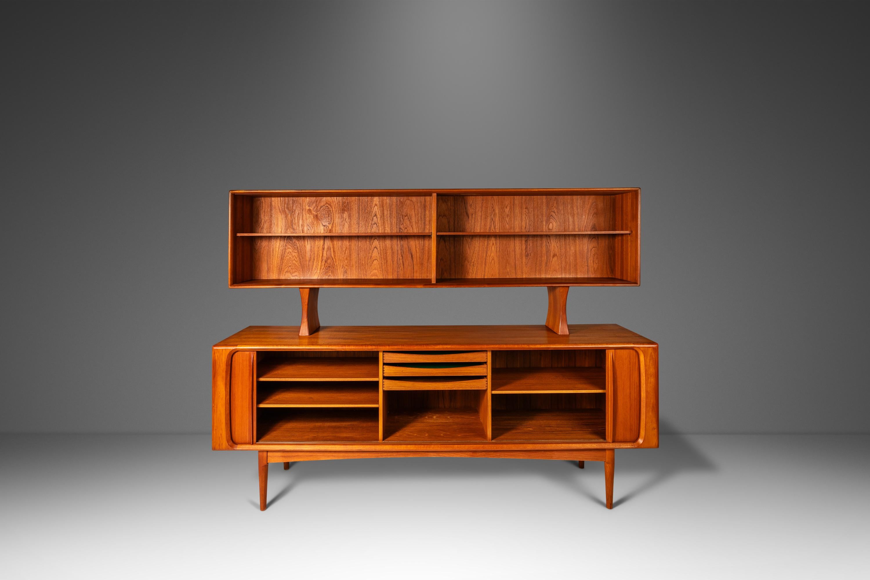 Audacious in scope, design and materials used this extraordinary Danish-made double decker credenza is as functional as it is visually arresting. Constructed from a mix of solid and matchbook-veneered Burmese teak this striking two-piece set is