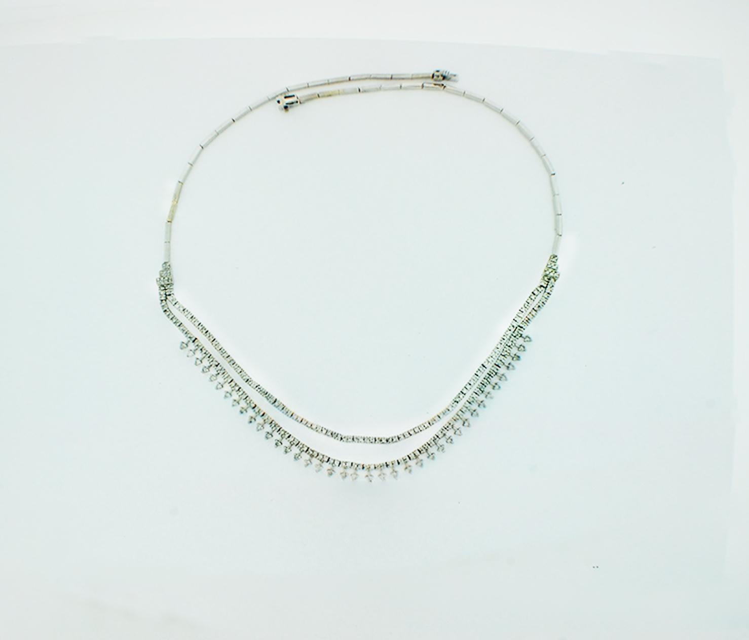 Elegant, 14 karat white gold diamond tennis necklace consists of (39) Round tear-dropped diamonds enhancing double strands of pave set diamonds of nearly 250 stones total.
The double strand graduates at a length of 16