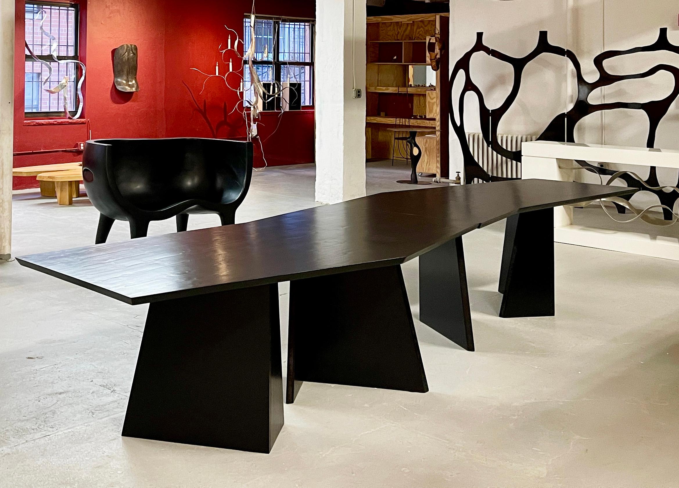 Sculptural  dining table in two sections, each 7 feet long, that can be joined together or used separately as needed.
One table can also be used as a desk. The angular legs and top give a sense of perpetual movement to the work as it animates its