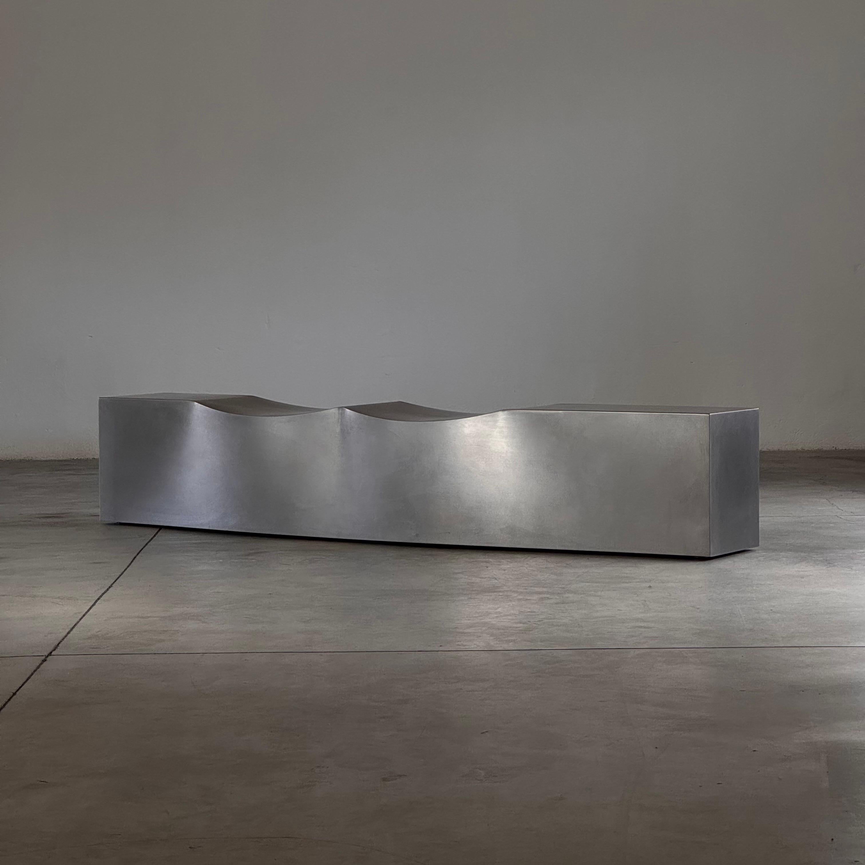 A rare and visionary piece of early 21st-century design, the “Double Dip” bench by Chris Howker for B&B Italia was introduced in 2004 as a bold fusion of industrial minimalism and sculptural form. Executed in 1.5 mm-thick stainless steel with a