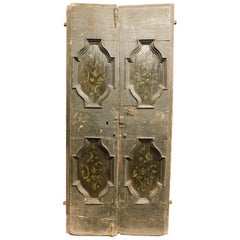 Double door in rustic larch wood, black background and painted panels, italy