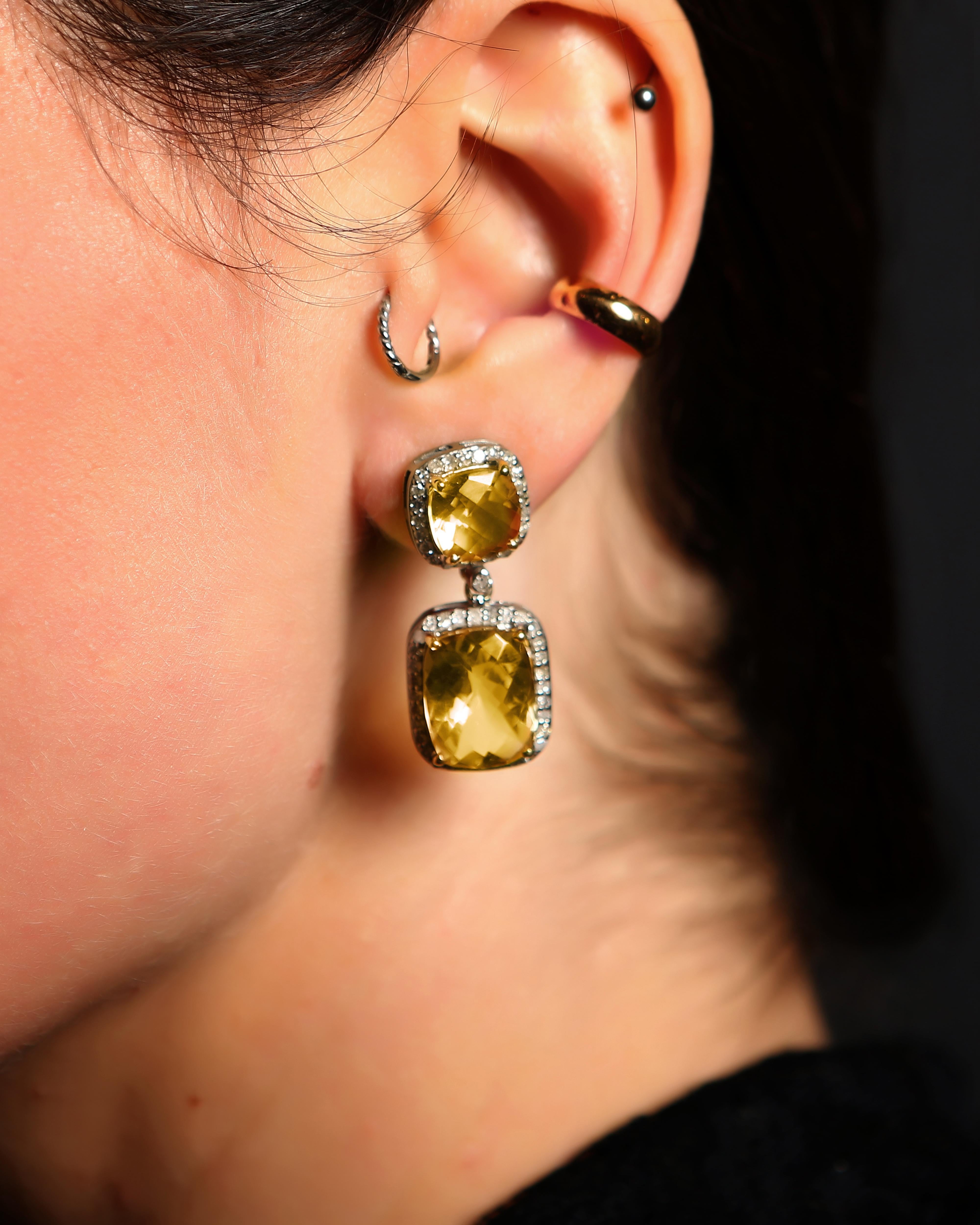 Set with the most beautiful citrine stones outlined with diamonds, these earrings are so classic, versatile & fabulous.

2.98 grams 14kt gold; 6.4 grams silver; 1.47 carat diamonds; 19.69 carat citrine.

3.4 cm in full length; very light weight for