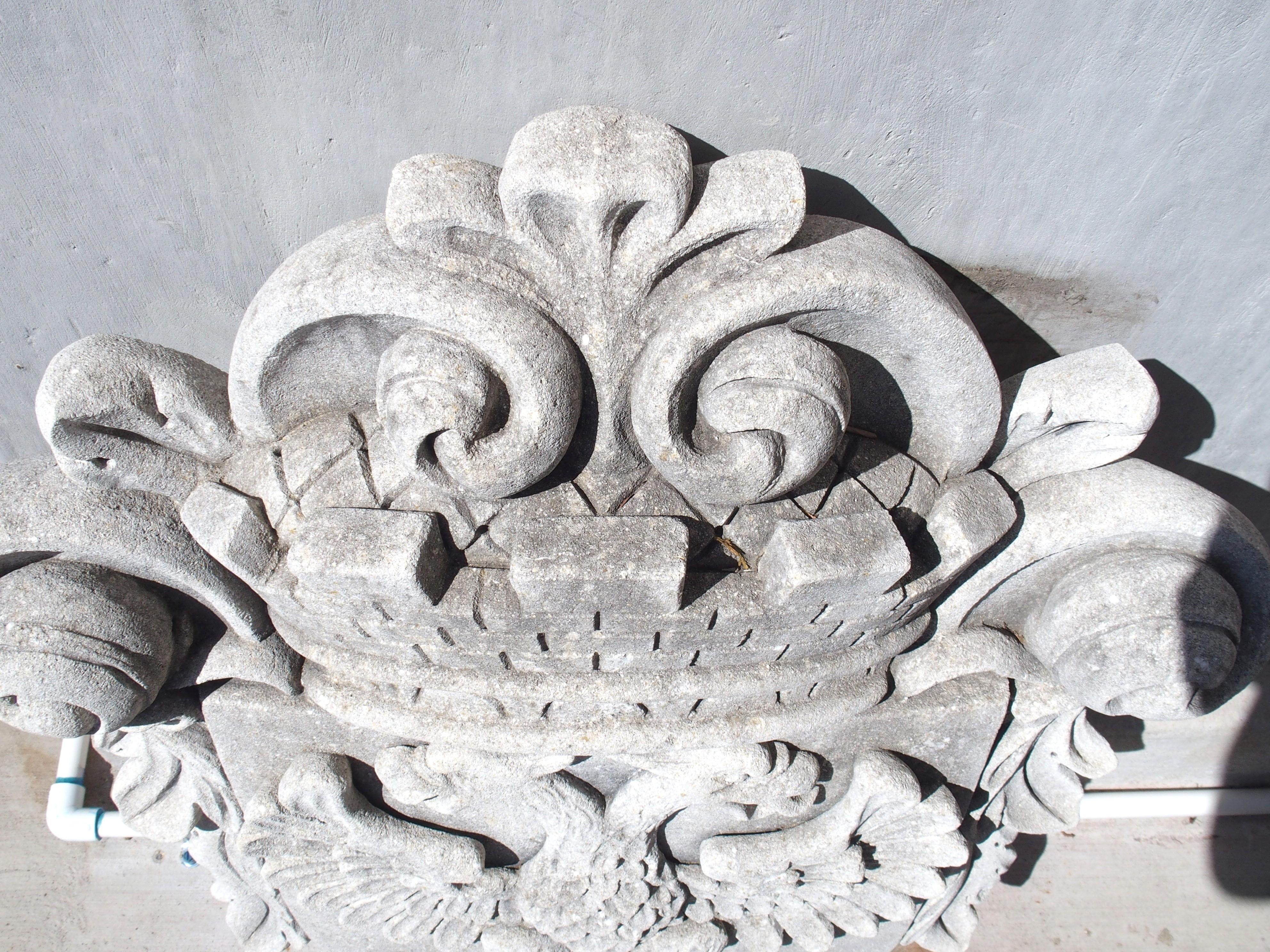 Reminiscent of a late 15th century coat of arms, this double eagle cartouche plaque has been hand-carved in limestone in Italy. A square top shield with a rounded base, known as “Iberian style”, has been emblazoned with a large double-headed eagle