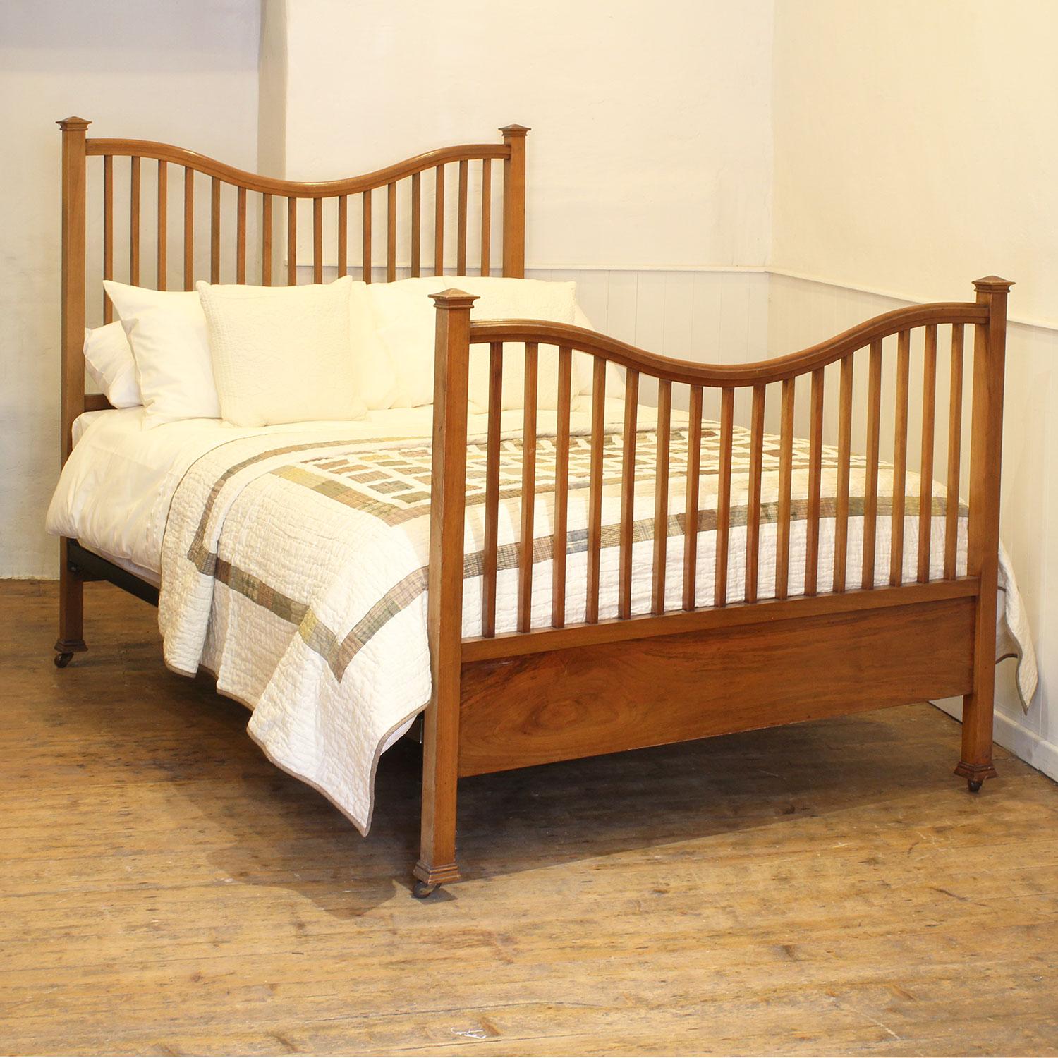 An atttractive Edwardian antique bed with square pagoda caps, slatted design and serpentine top rails.

This bed accepts a standard double, 4ft 6in (54 in), base and mattress set.

The price is for the bed frame and a firm bed base. 

The