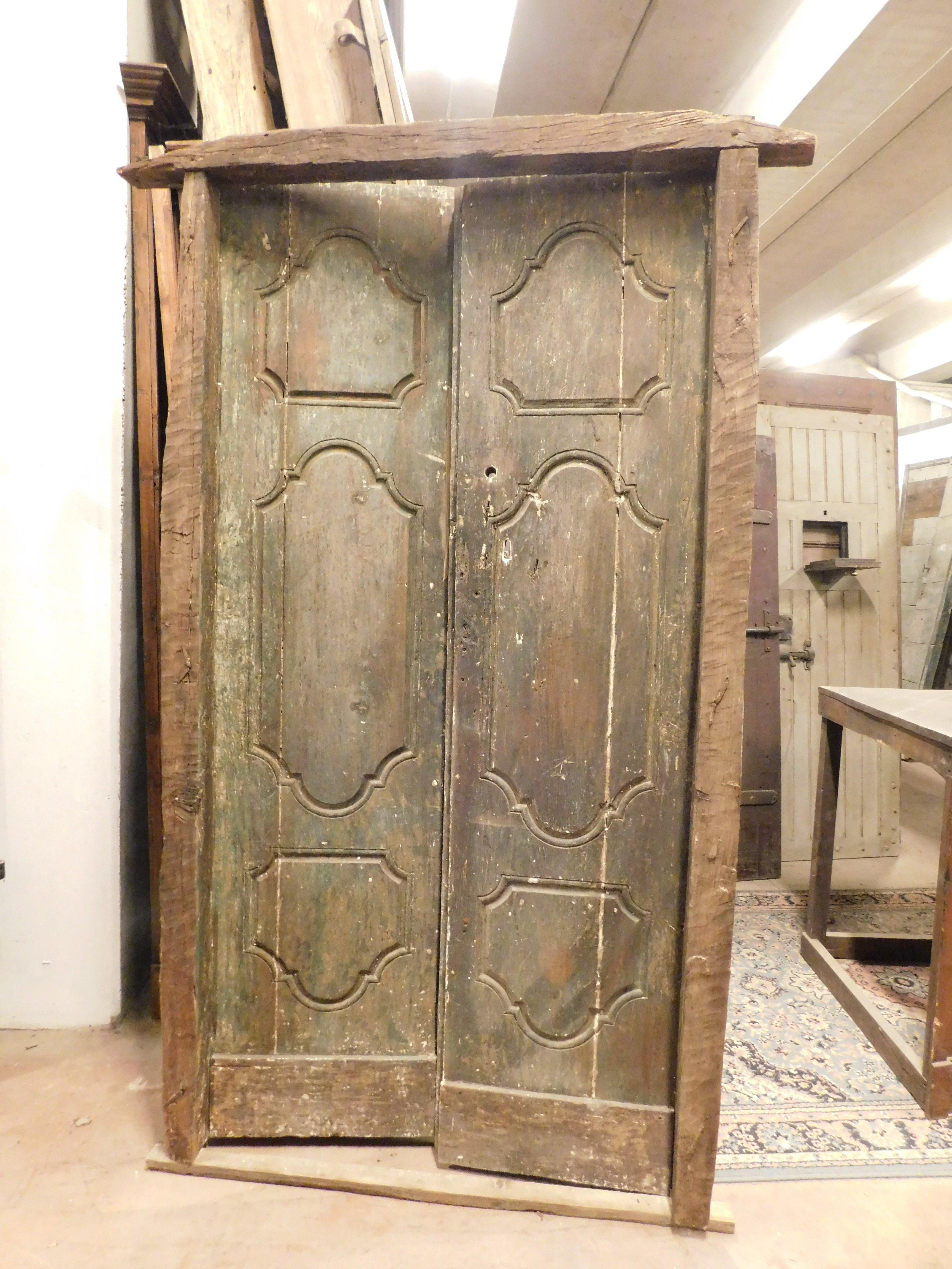 Ancient entrance door, double wing with original frame, built with solid chestnut wood and carved tiles, beautiful patina of time which has changed the green lacquering, built in northern Italy in the 18th century. Possibility of using it both as an
