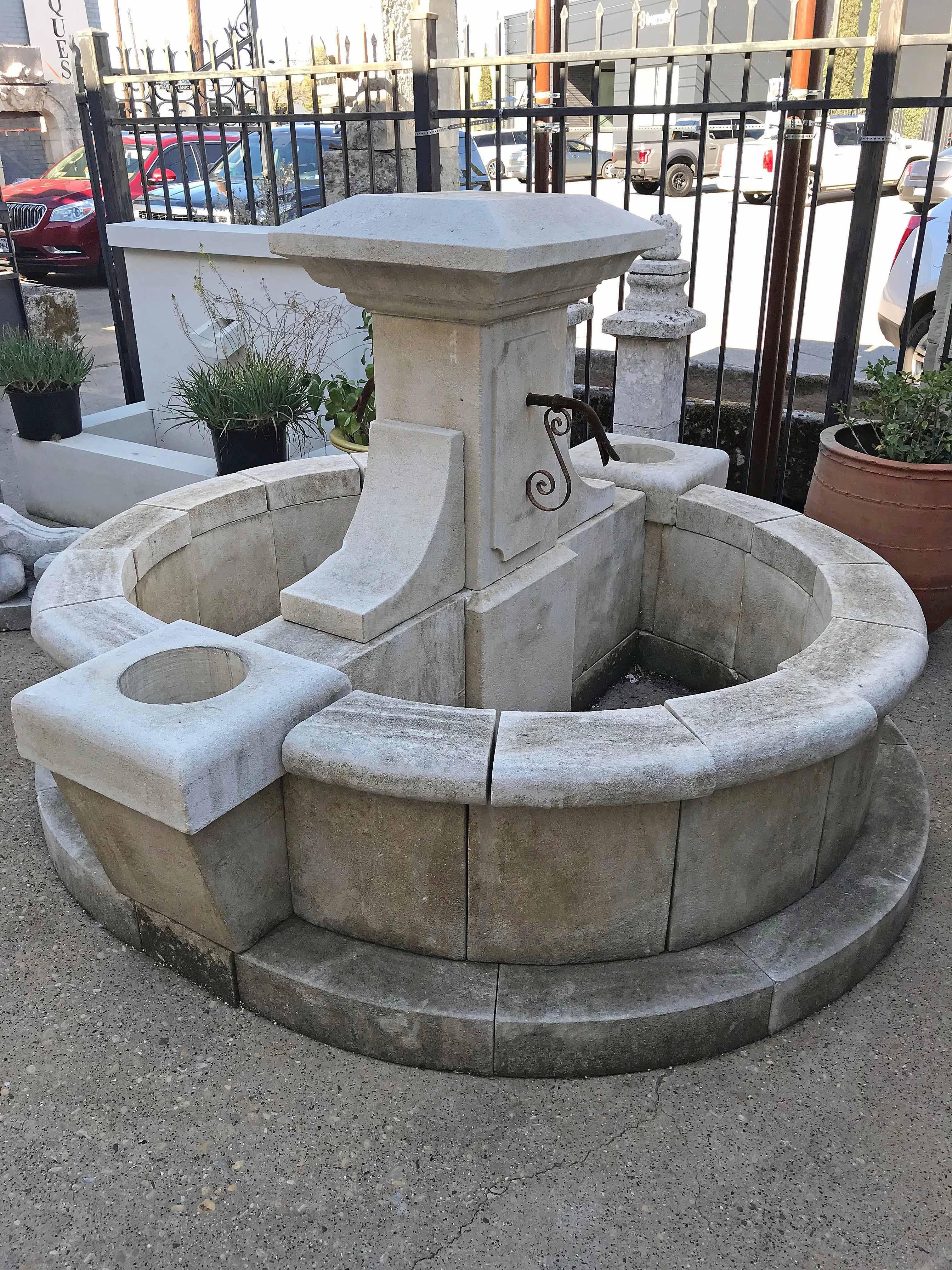 Central fountain complete with base, surround, a spout on each side of the fountain as well as a planter on each end of the fountain.