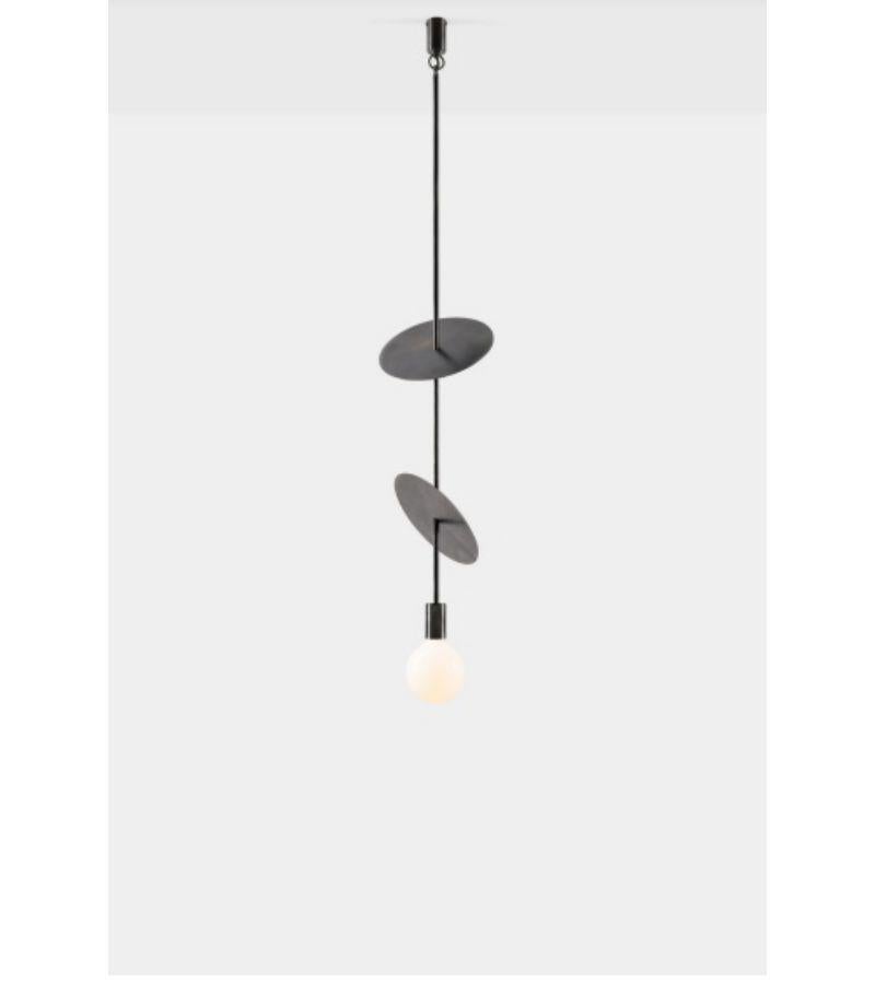 Double flipside solid pendant light by Volker Haug
Dimensions: Diameter 25 x H 78.5 cm 
Material: Brass. 
Finishes: Polished, Aged, Brushed, Bronzed, Blackened, or Plated
Lamp: 240V E27 (120V E26 US) (pictured with L087 95mm opal LED)
Lamp: