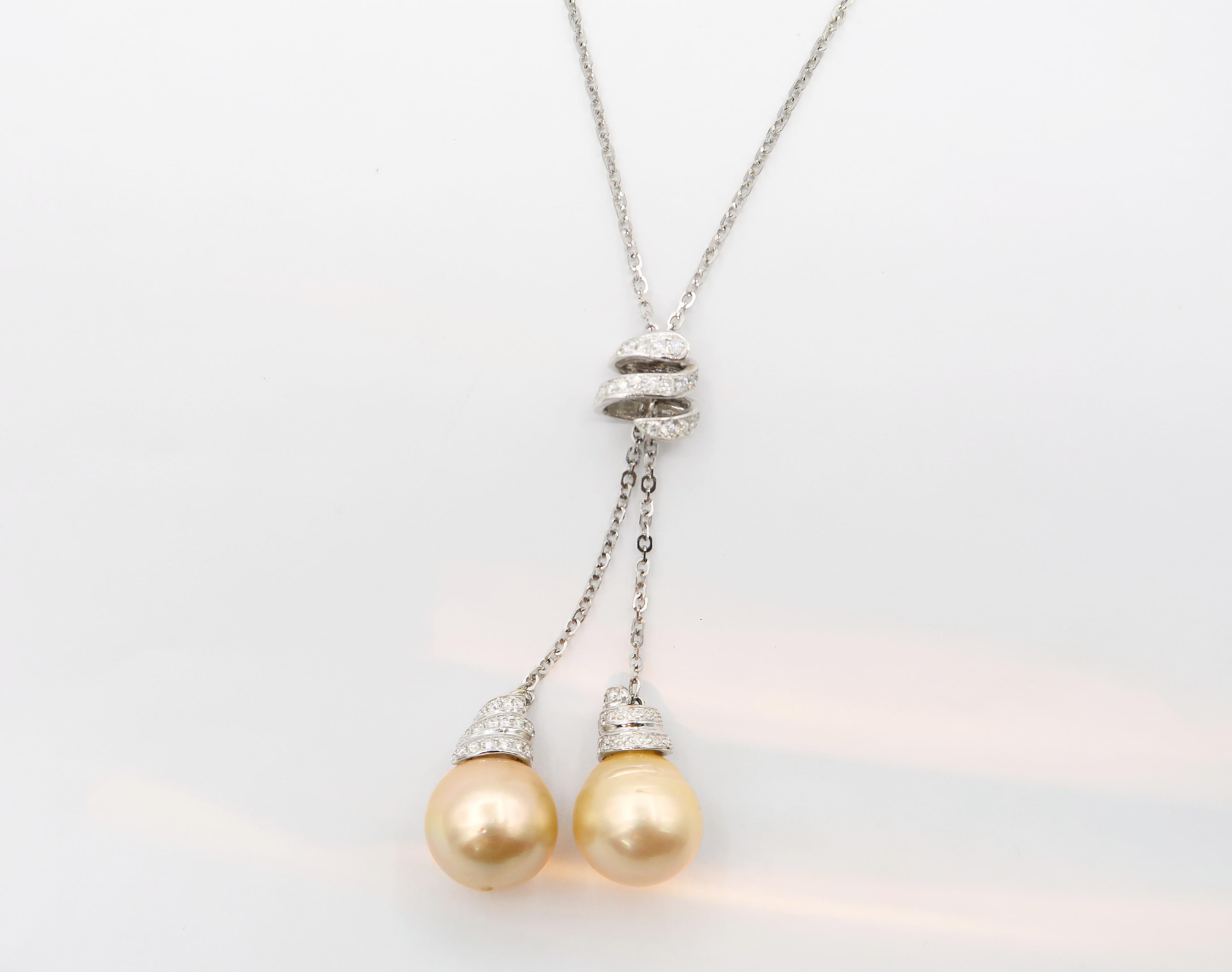 Double Golden South Sea Pearl Drop Necklace in 18K White Gold with Diamonds

Length: 16 inches

Gold: 18K White Gold, 12.98 g
Diamond: 0.78 ct
Pearl: 2 pieces, Golden South Sea, 14.5 mm