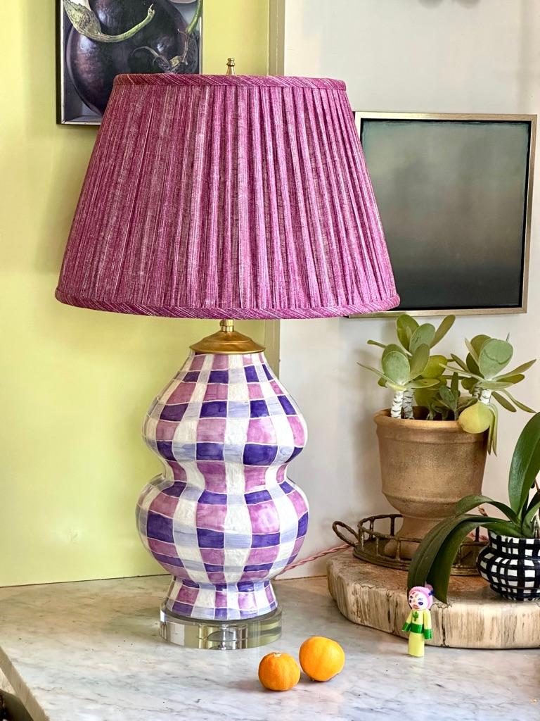 Traditional gourd form clad in exuberant, hand-painted plaid patterning. Available in 6 colors.

ceramic | crystal base | live brass | 9 x 9 x 18 “T, hardware adds 3” | twisted cloth cord

Shown in Violet topped with Fermoie’s 16” pleated round