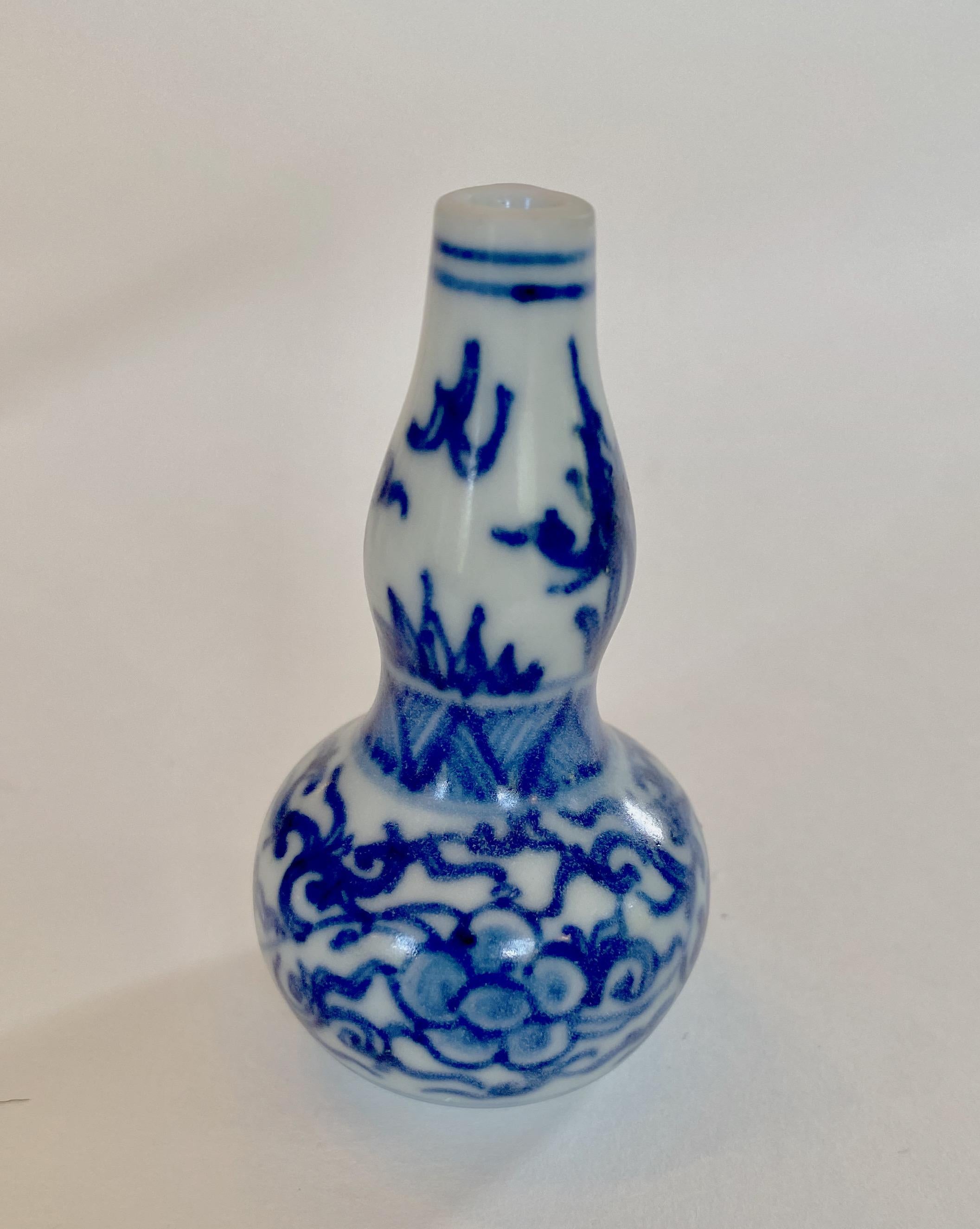 Miniature 17th century blue and white double gourd vase. 
This miniature vase was part of a hoard recovered by Captain Michael Hatcher from the wreck of a ship that sunk in the South China sea in approximately 1643. Approximately 25,000 pieces from