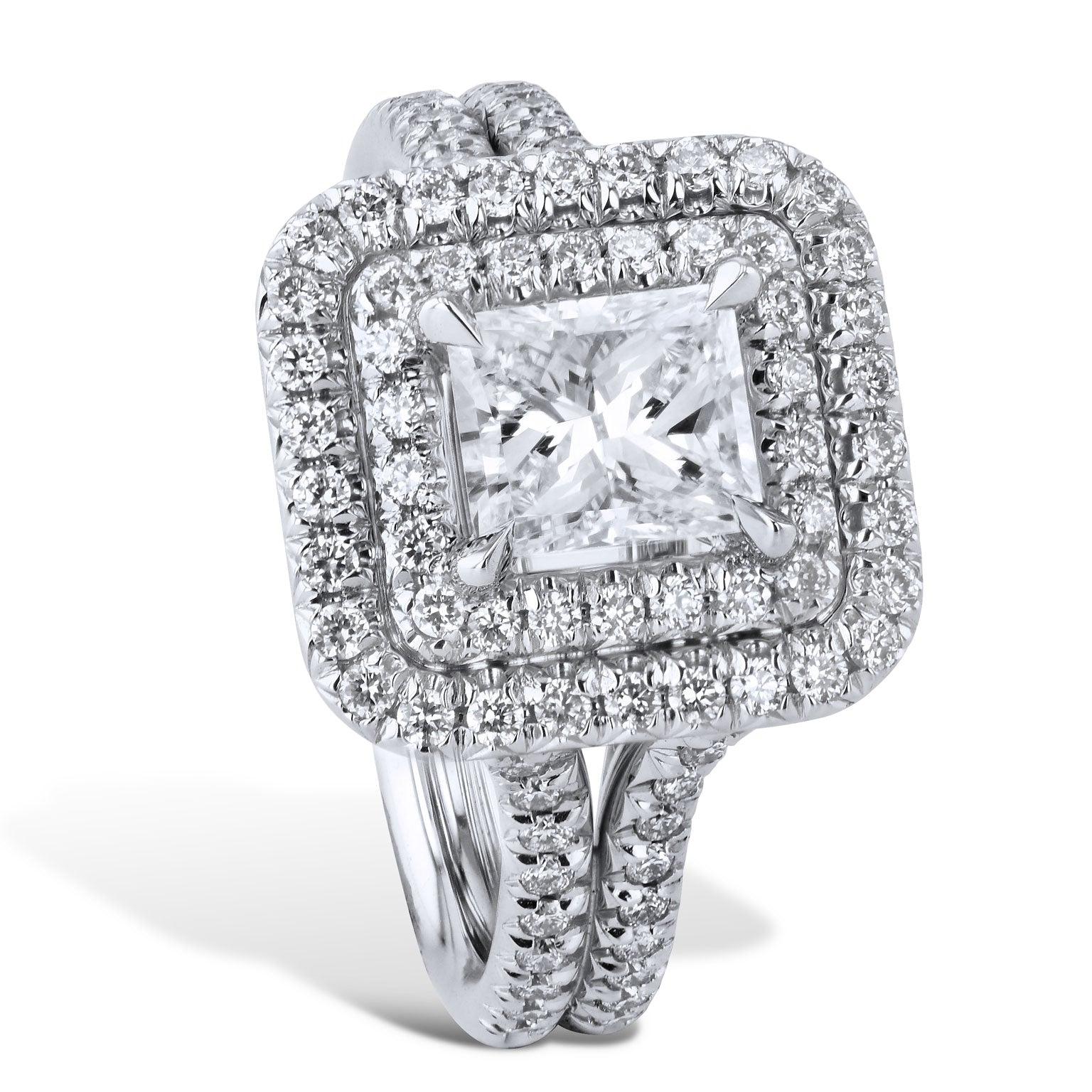 This stunning ring features 1.00 carat Radiant cut diamond. 
The color and clarity are (F/SI1).
There is an additional 0.55 carats in total weight of pave set diamonds featured in a platinum double halo and split shank band. 
This center stone is
