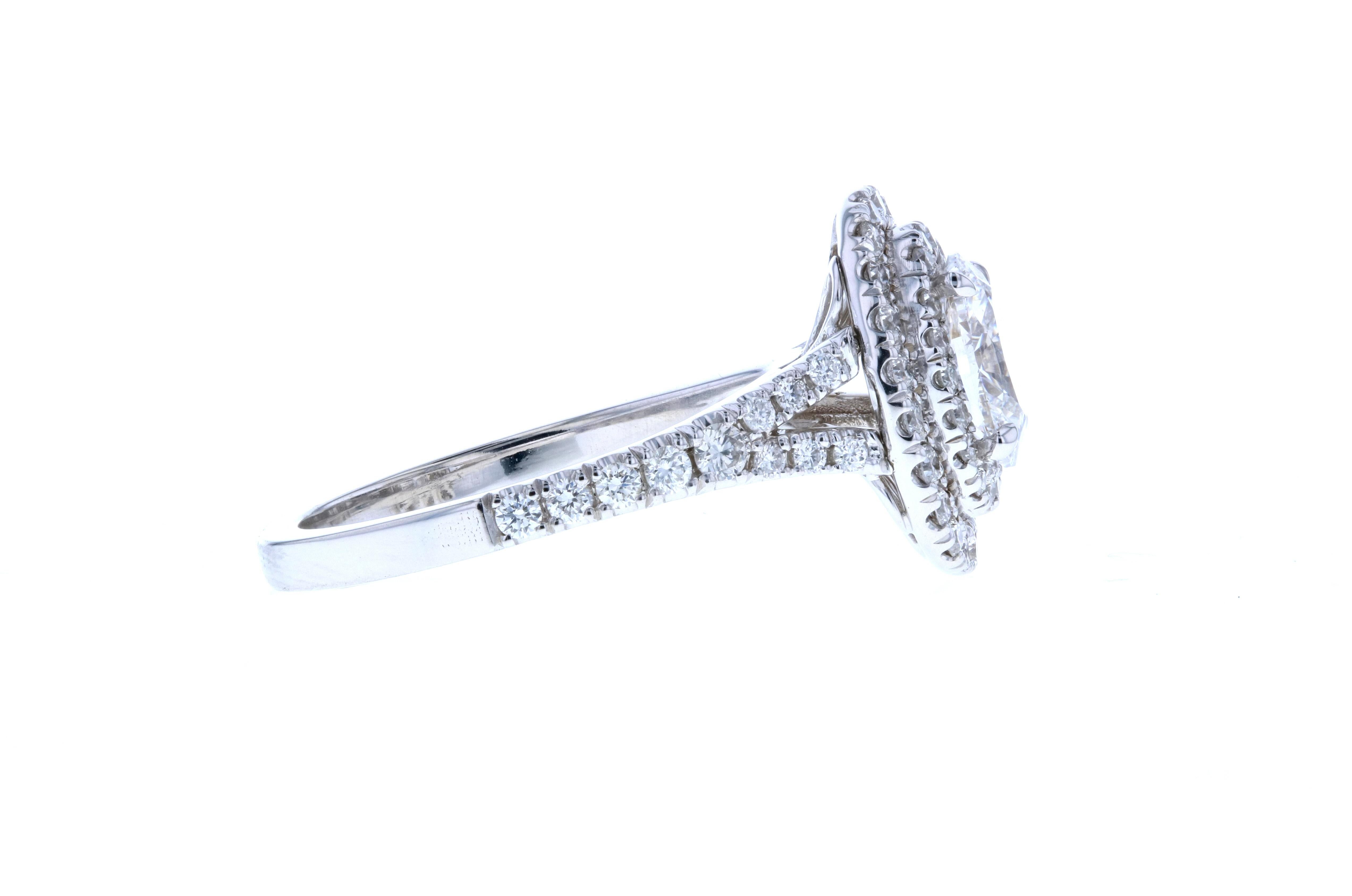 A stunning double halo diamond engagement ring with an oval center offers an incredible basket that reveals six elegantly open leaves to hold the center stone. A split shank covered in diamond pave completes the look!  

Please be advised that we