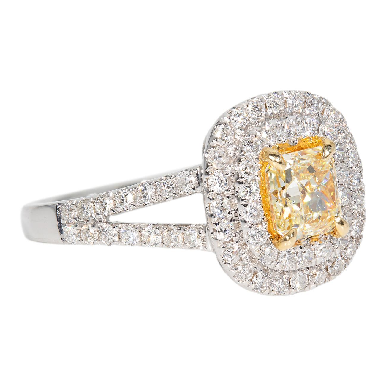Double halo split shank ring in 18K white gold with pave set rounds and prong set fancy yellow radiant cut diamond center.  D1.25ct.t.w.  (Center - 0.66ct.)