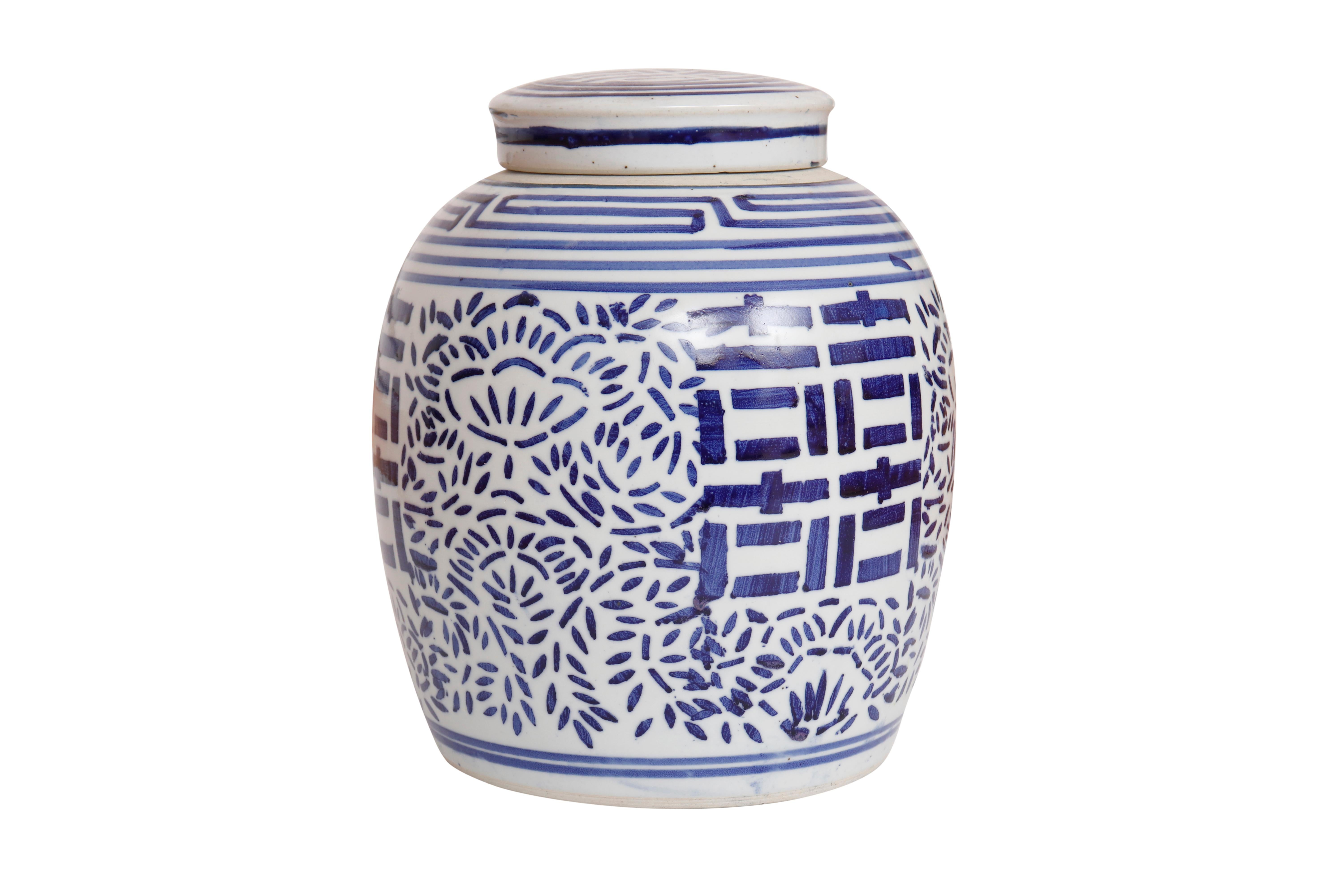 A blue and white Chinese ceramic ginger jar with matching lid. Hand painted with the double happiness symbol framed with a floral motif in bold cobalt blue.