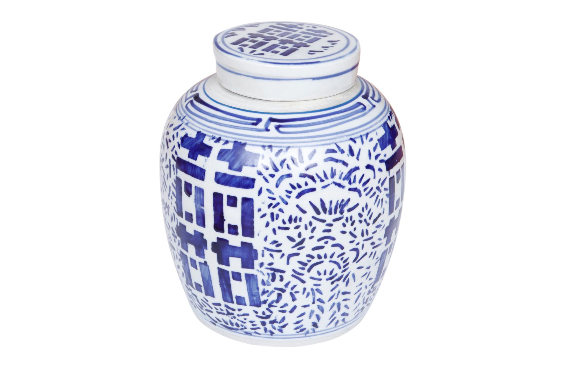 A blue and white Chinese ceramic ginger jar with matching lid. Hand painted with the double happiness symbol framed with a floral motif in bold cobalt blue.