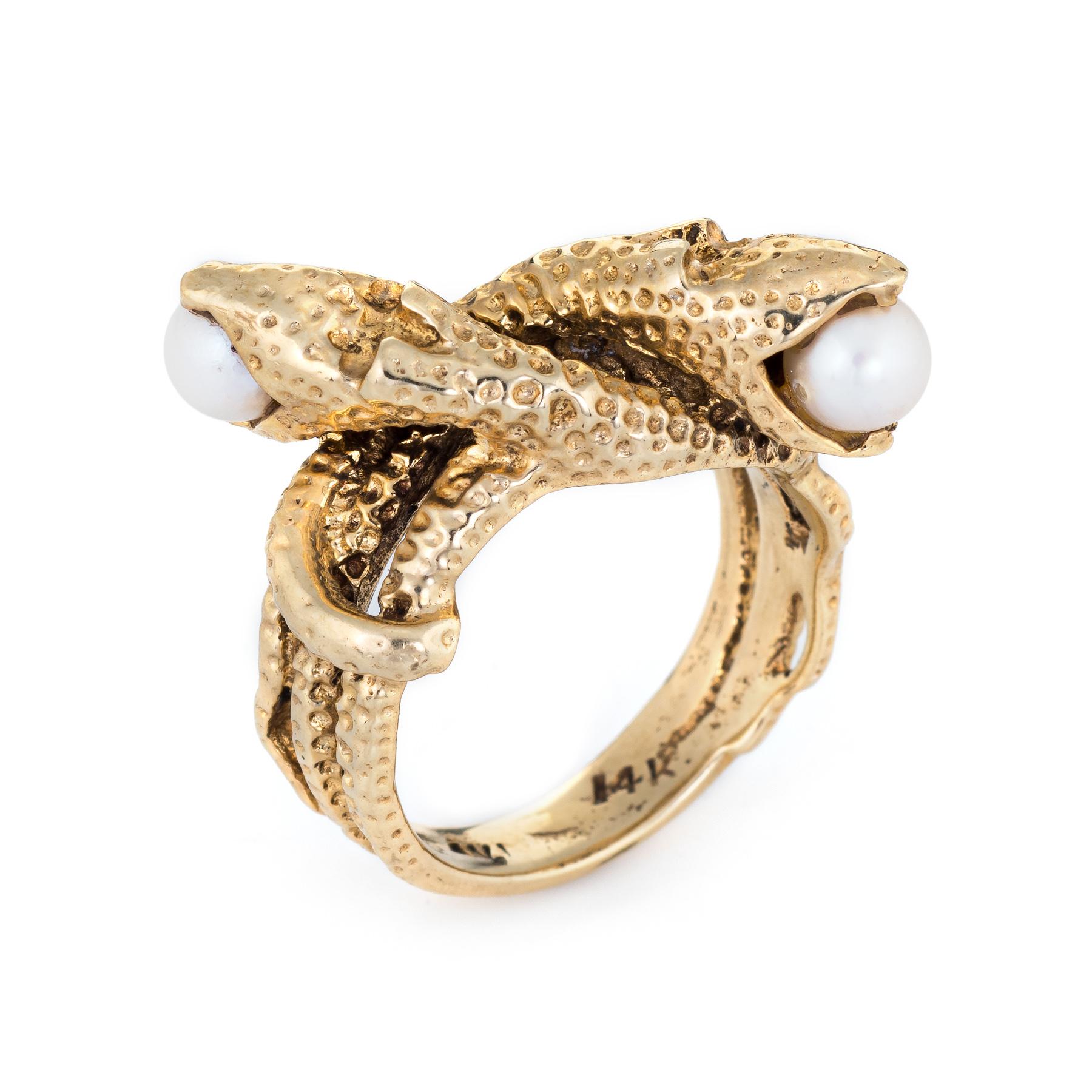 Finely detailed vintage double headed snake ring, crafted in 14 karat yellow gold. 

Two cultured pearls measure 5mm and are set into the snakes mouth. 

The two snakes face in opposite directions with cultured pearls set into each mouth. The body