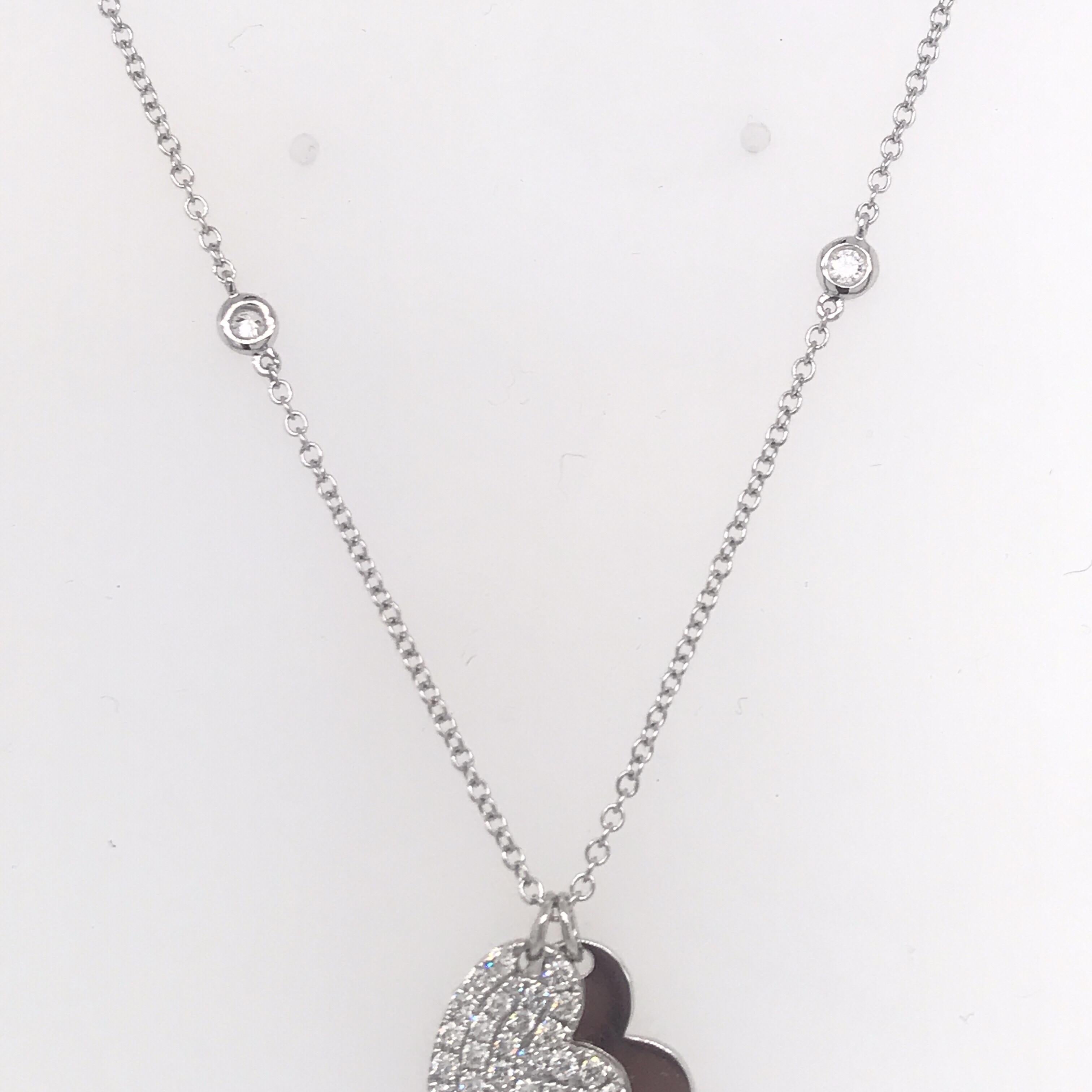 18K White gold pendant featuring two hearts, one solid white gold, and a diamond heart with 39 diamonds weighing 0.52 carats.
Solid heart can be engraved!
Color G-H
Clarity SI