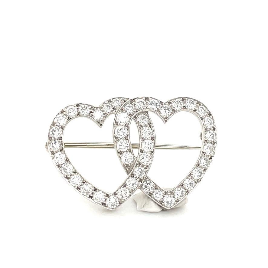 Bright and beautiful intertwined double heart pin.  Set in platinum.  Encrusted with brilliant diamonds.  Petite size -- 1
