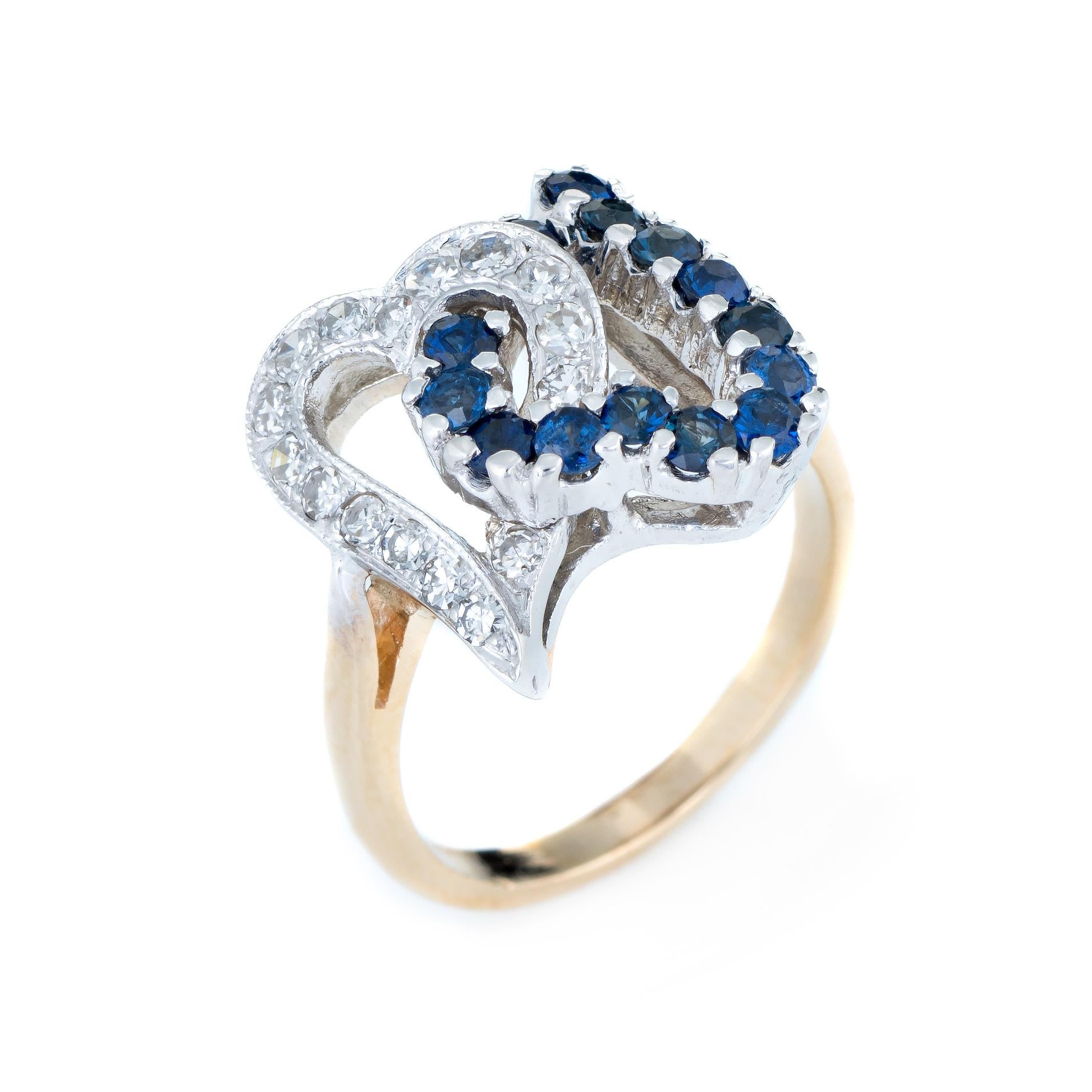 Finely detailed vintage double heart sapphire & diamond cocktail ring, crafted in 14 karat yellow gold. 

14 blue sapphires total an estimated 0.28 carats, accented with an estimated 0.20 carats of single cut diamonds (estimated at G-H color and