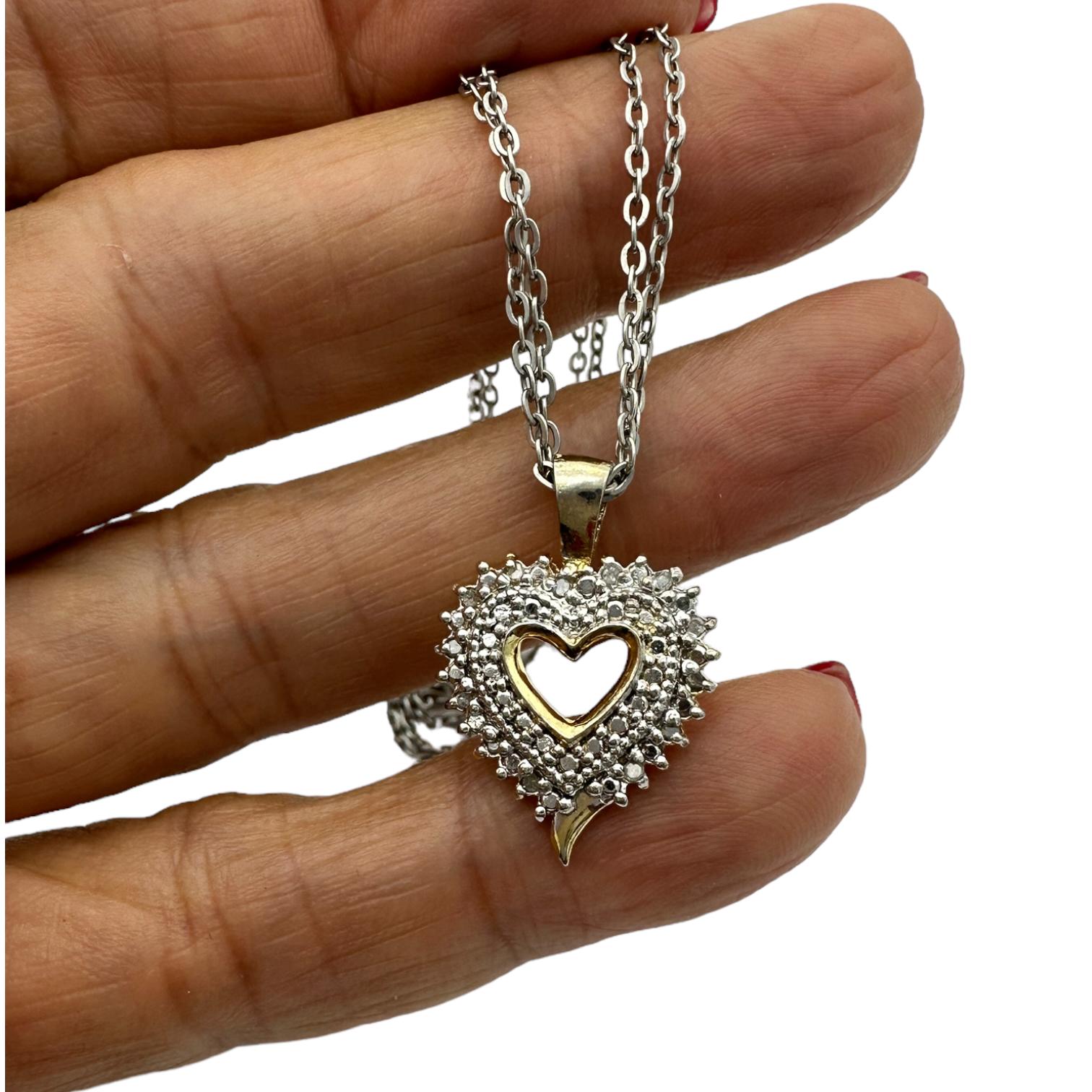This stunning pendant radiates elegance with its double heart halo design. It features .05 carats of diamonds, set in a 925 sterling silver chain—an ideal piece for jewelry wearers who want to show off their romantic side.
Open diamond heart pendant