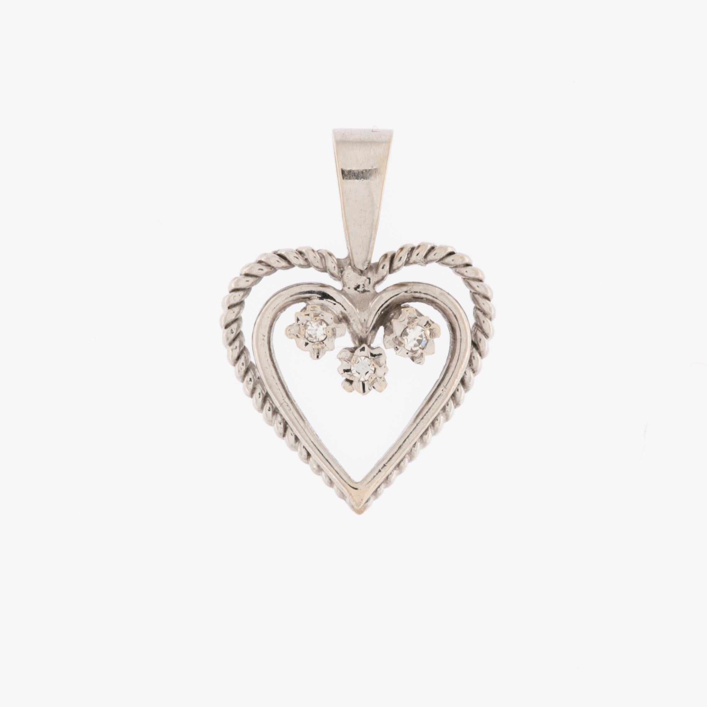 The Double Heart Pendant in White Gold with Diamonds is a romantic piece of jewelry that showcases intricate craftsmanship and elegance. Crafted from 18-karat white gold, this pendant features a unique design with two intertwined hearts, symbolizing