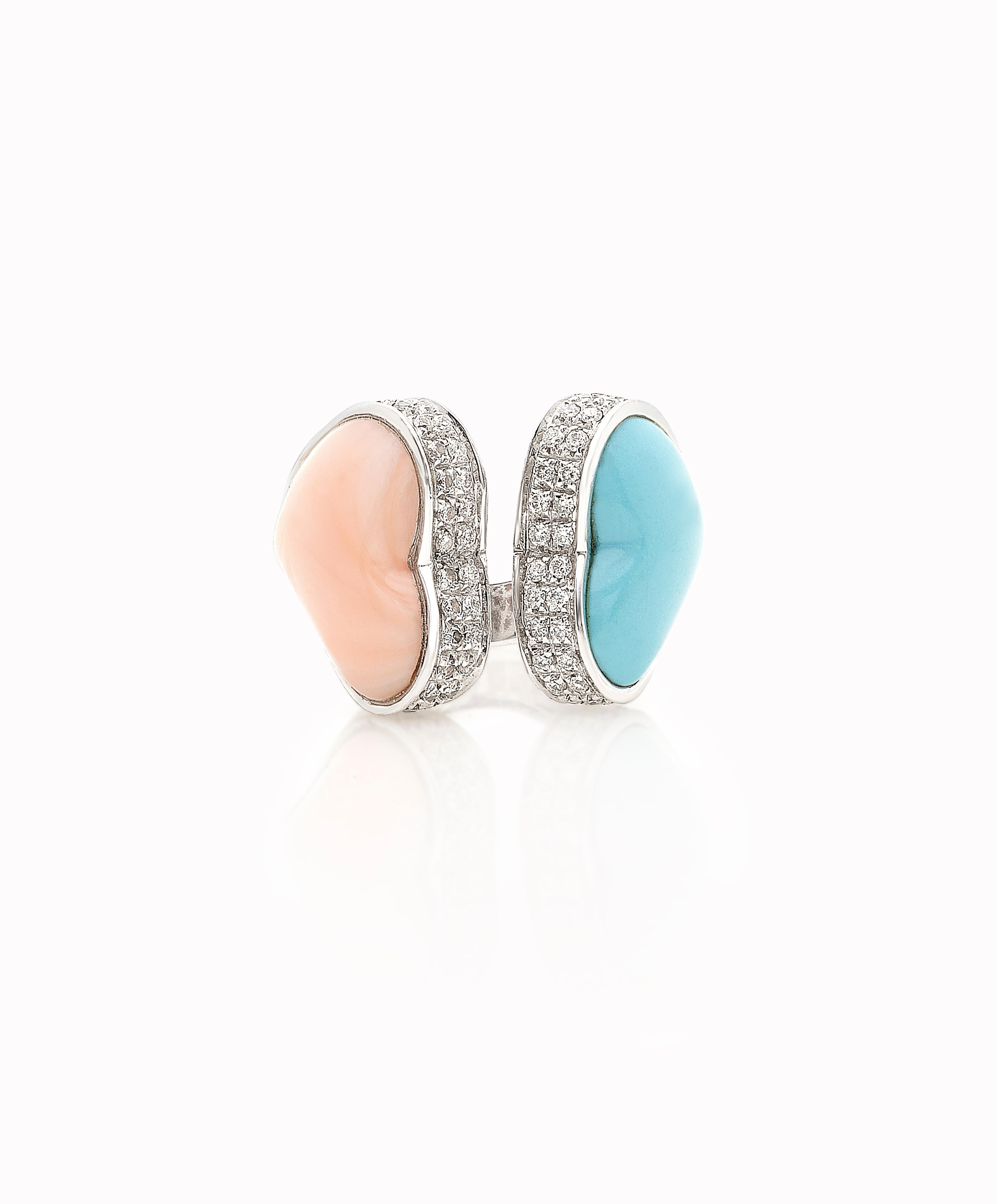Double Heart Ring in coral, turquoise and diamonds in 18kt white gold.
The ring is made of two hearts that are set in the white gold and surrounded by 1.6 white diamonds.  
Each side has a heart: each one is the mirror of the other one.  
When the