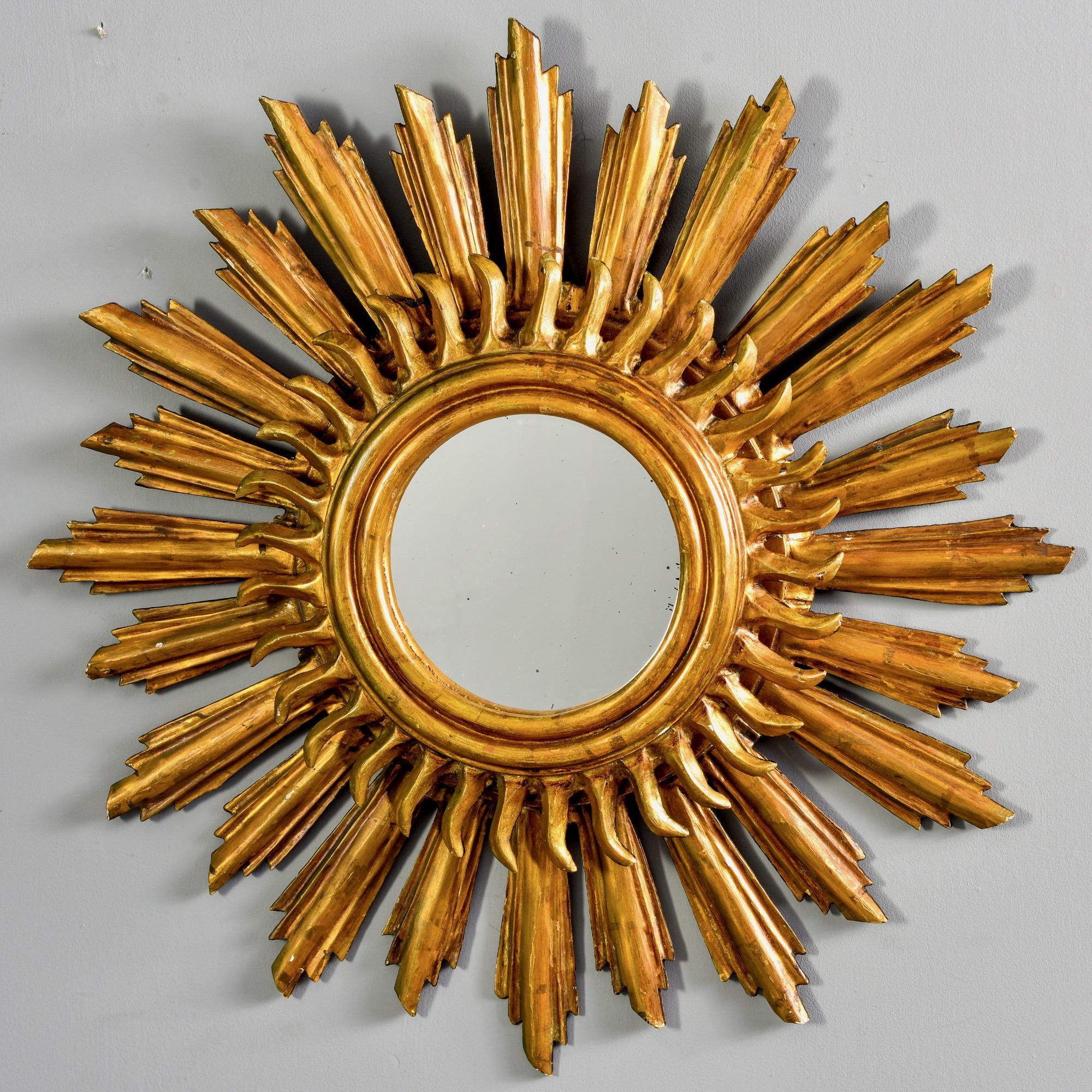 Found in England, this circa 1930s sunburst mirror is made of gilded wood and features a double layer of rays with a round mirror at the center. Unknown maker.

Actual mirror size: 7.5” diameter.