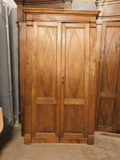 Double-leaf door, in poplar wood with carved panels and frame, Italy