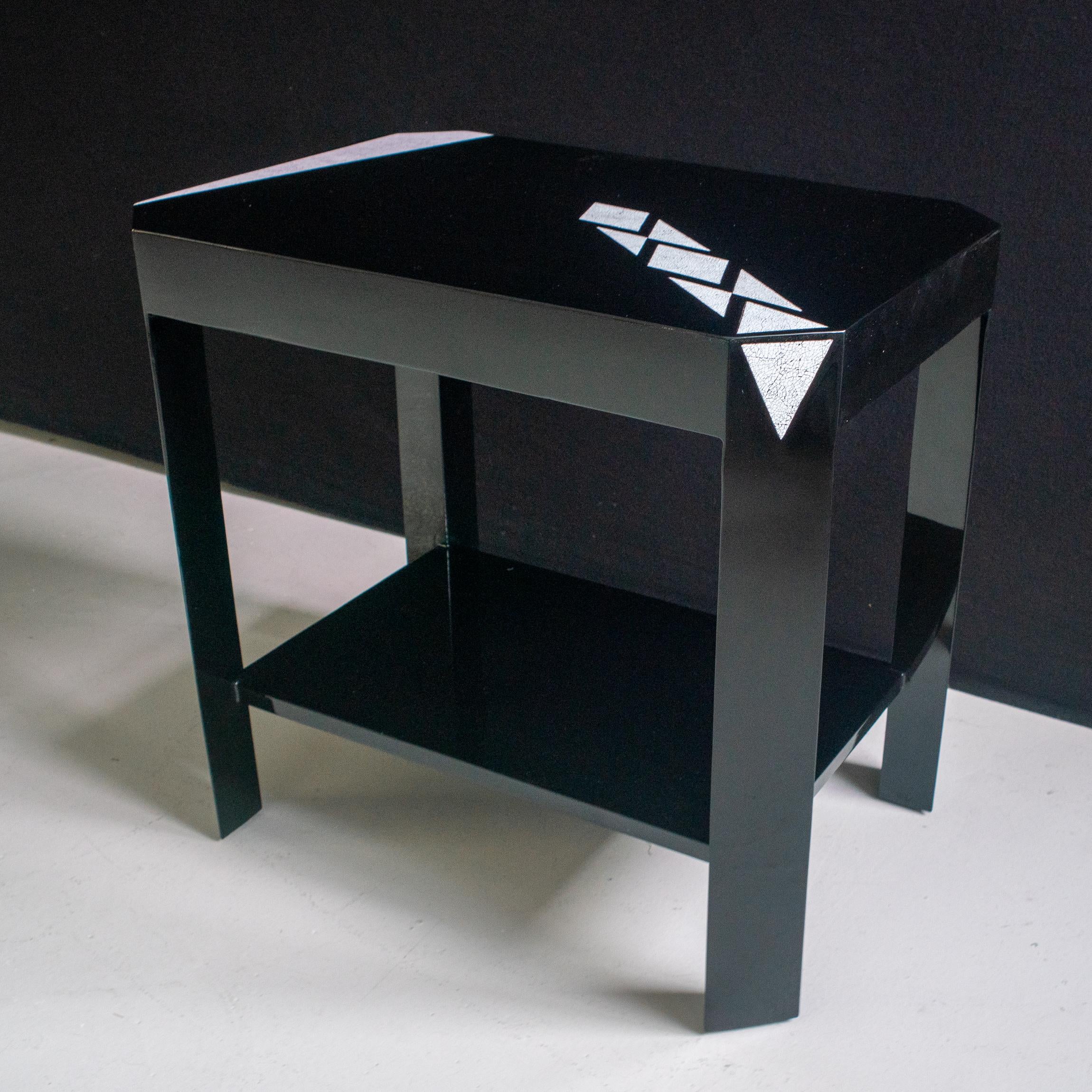 Two level side pair of side tables in black lacquer with sober eggshell design.
