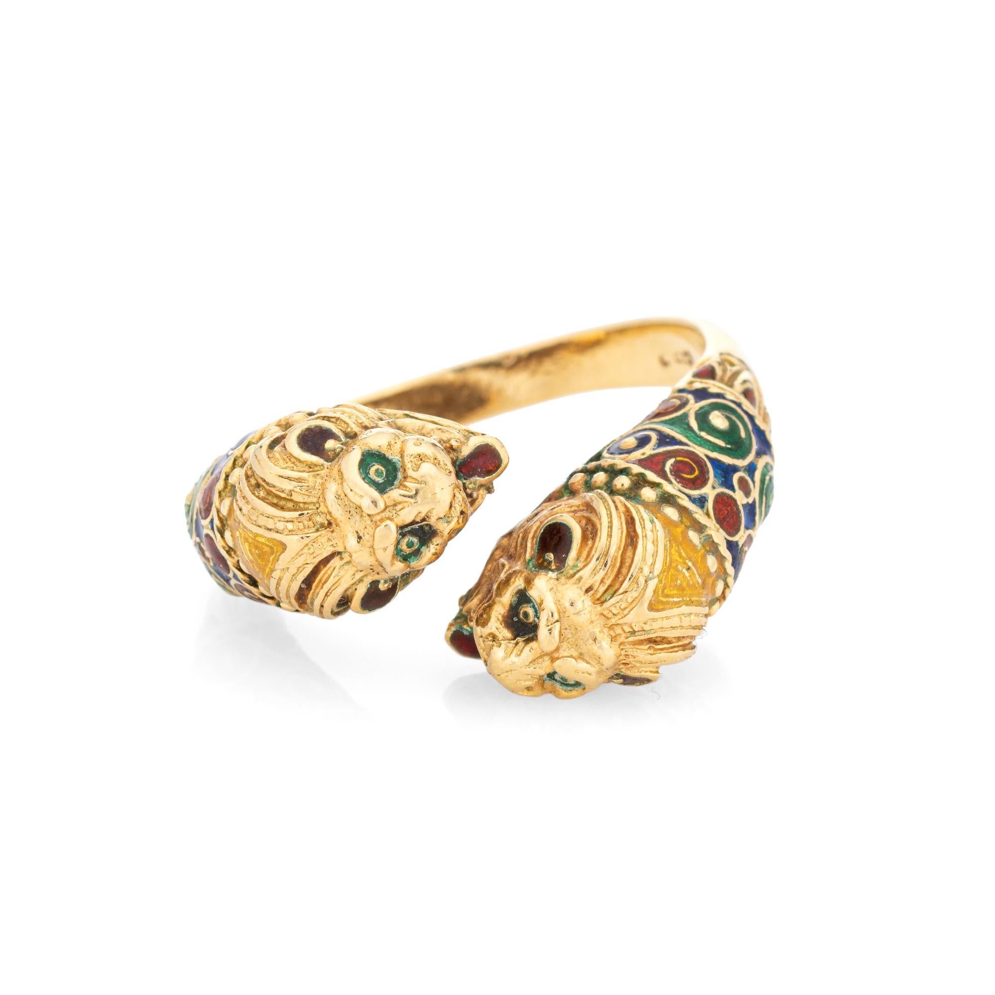 Stylish vintage double Lion ring crafted in 18 karat yellow gold (circa 1980s). 

The elaborate double Lion features a blue, green and orange enameled patterned body, The double headed Lion bypass design makes a great statement on the hand. The low
