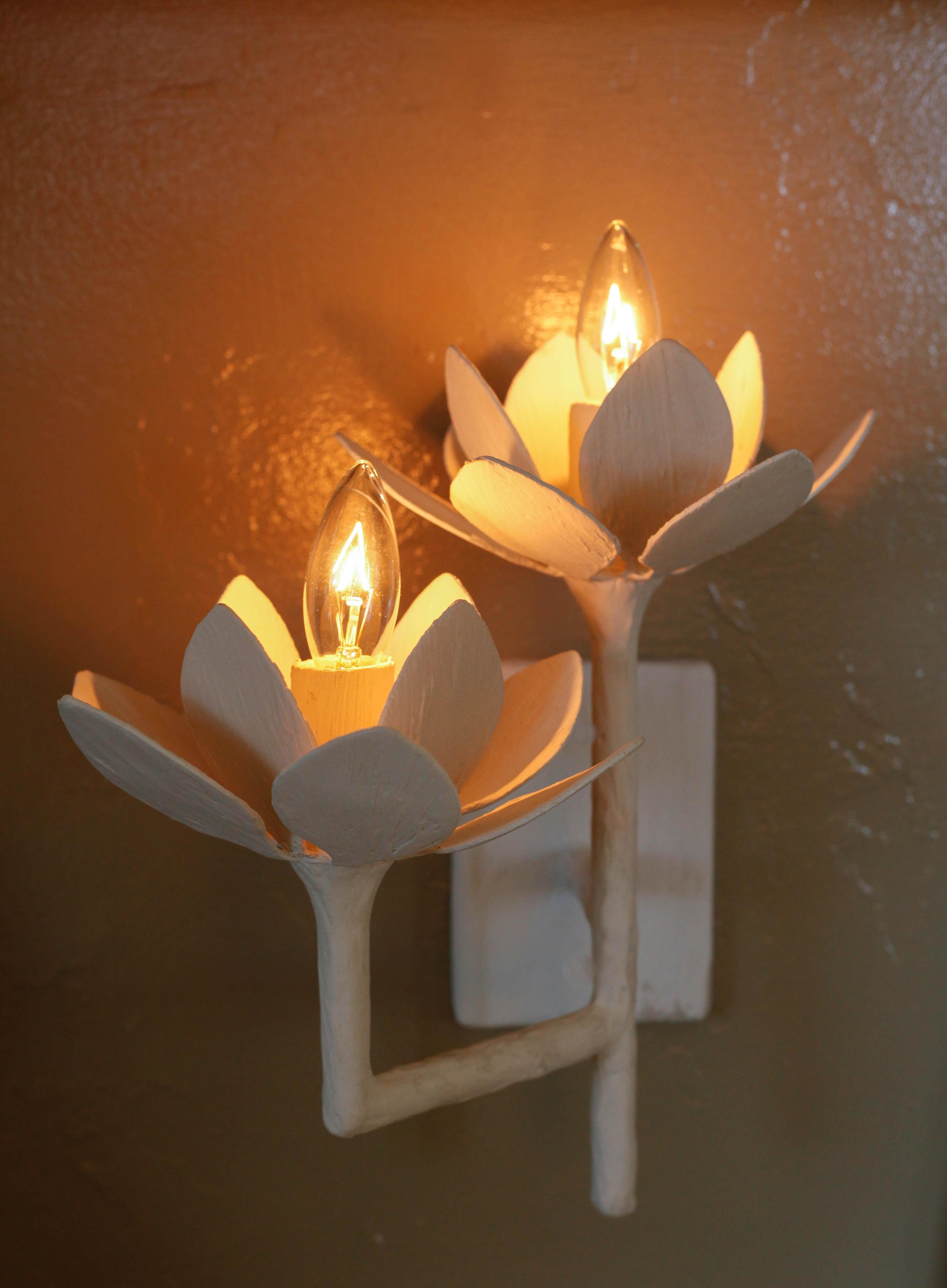 Double applique en forme de fleur de lotus par Tracey Garet de Apsara Interior Design. Chaque fleur de 6,5 pouces de diamètre contient une lumière individuelle. La fabrication est en plâtre sur des tubes d'acier. Le dessin présenté est en plâtre